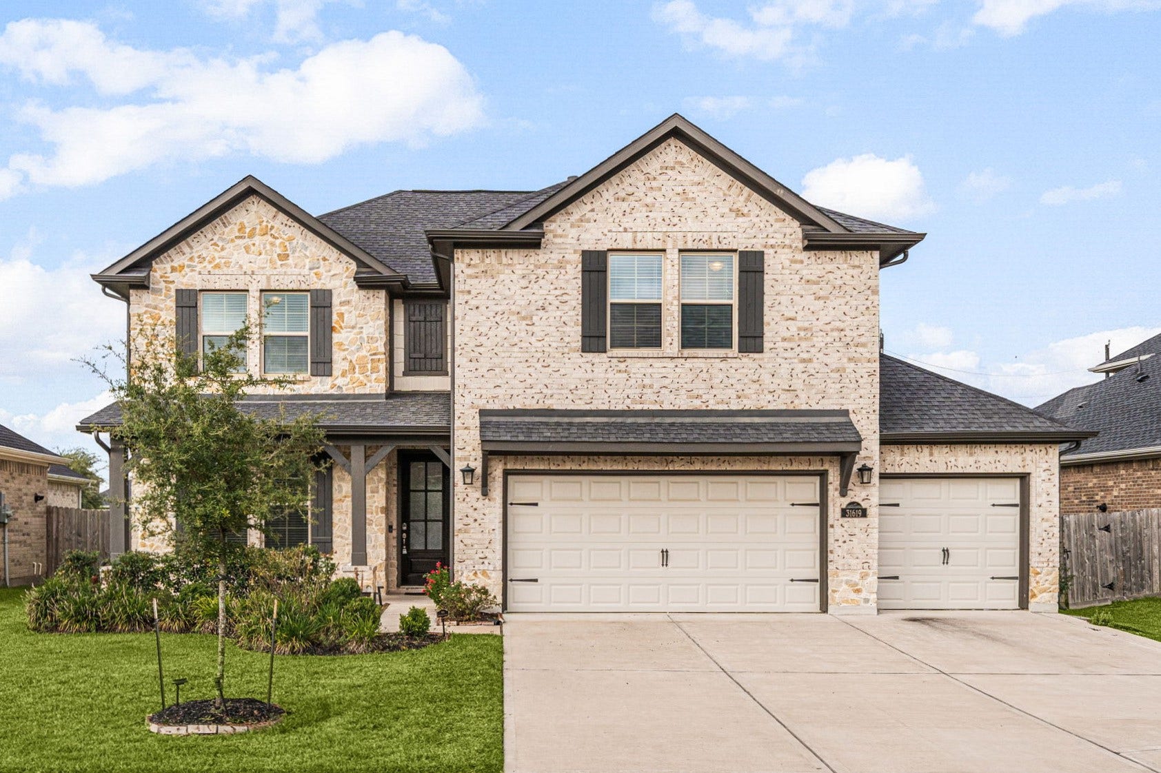 31619 Donoso Drive, Fulshear, TX 77441 Welcome to 31619 Donoso Drive, in the Polo Ranch community. The extended concrete driveway leads to the impressive 3-car garage, framed by a beautifully landscaped front yard, just a hint of the established garden and thoughtful upgrades found throughout this home.