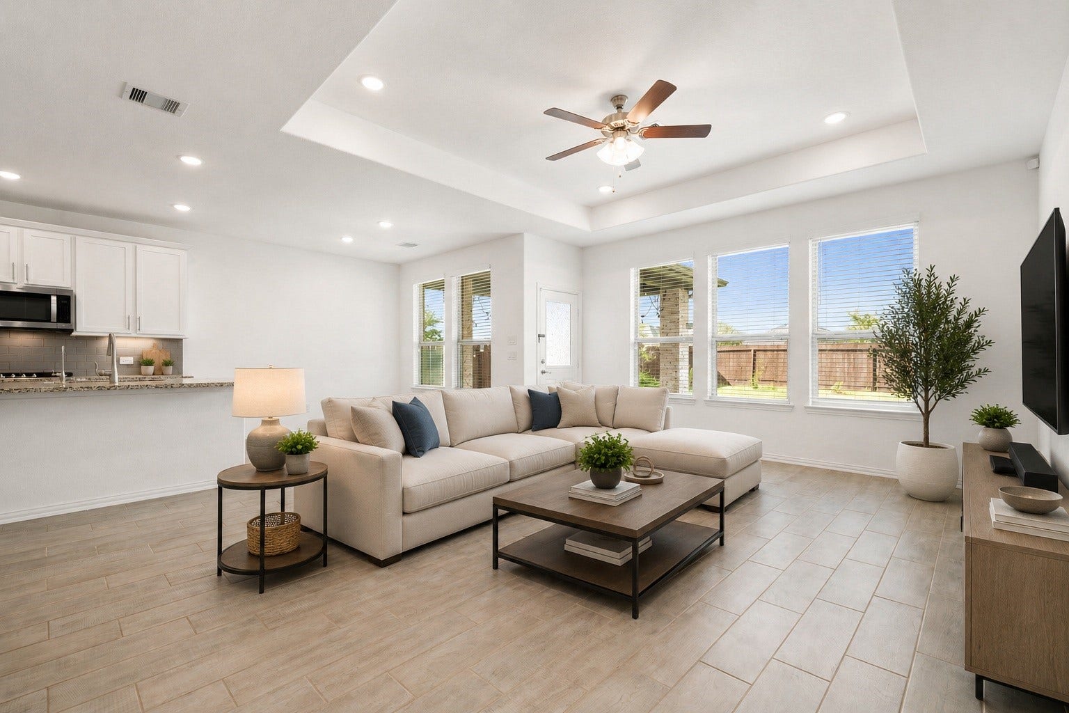 31619 Donoso Drive, Fulshear, TX 77441 This inviting living space opens directly to the kitchen for easy everyday flow, with abundant natural light and a door leading out to the backyard. Virtually staged.