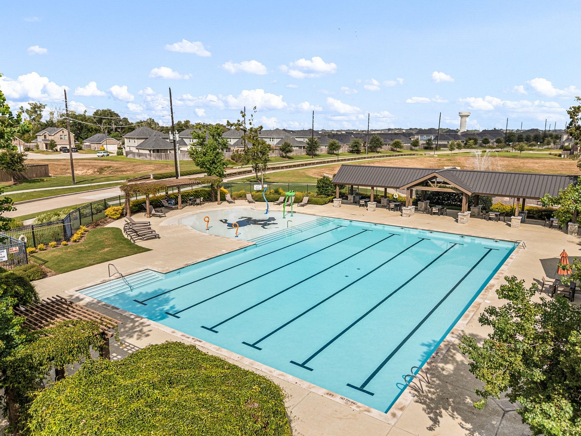 31619 Donoso Drive, Fulshear, TX 77441 Polo Ranch residents enjoy a community pool and recreation center, creating a convenient place to cool off and unwind close to home.