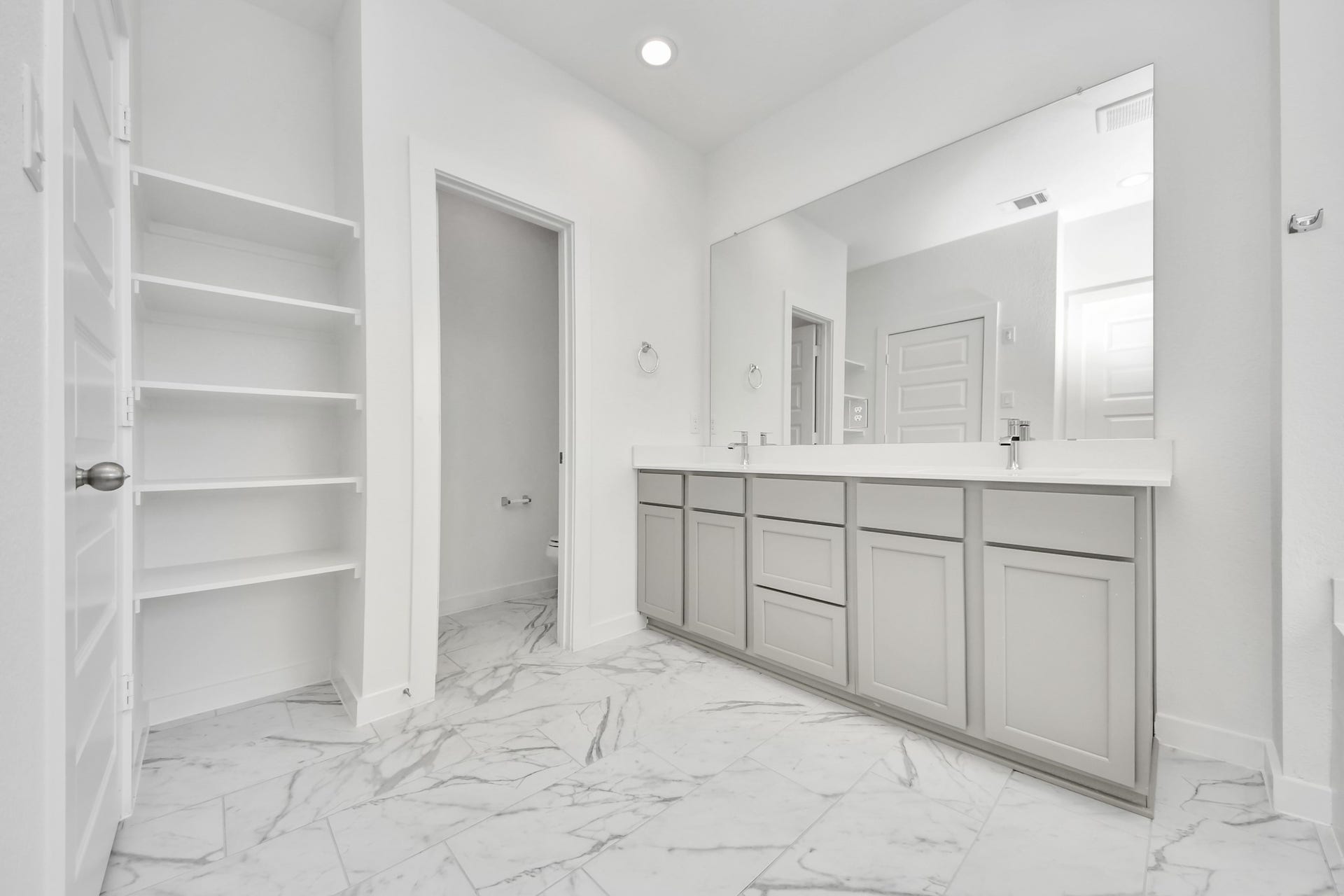1021 Golden Glow Path, Magnolia, TX 77355 Elevate your daily routine at the elegant vanity, now equipped with double sinks, light countertops, modern hardware, and beautiful recessed lights. Sample photo of completed home with similar floor plan. Actual colors and selections may vary.