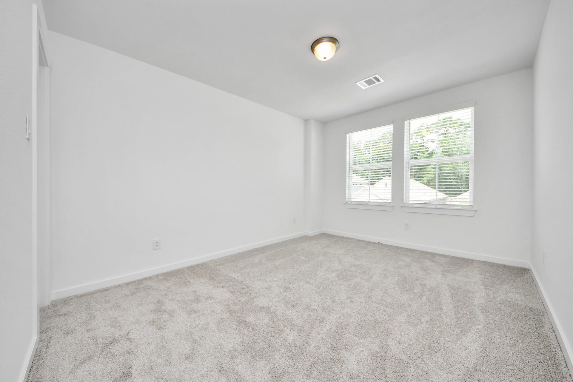 1021 Golden Glow Path, Magnolia, TX 77355 Generously sized secondary bedrooms featuring spacious closets, soft and inviting carpeting underfoot, large windows allowing plenty of natural light, and the added touch of privacy blinds for your personal retreat. Sample photo of completed home with similar floor plan. Actual colors and selections may vary.