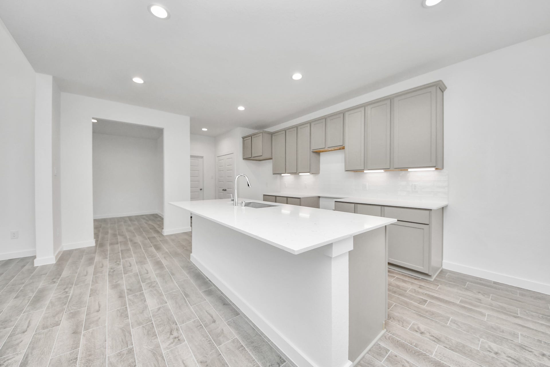 1021 Golden Glow Path, Magnolia, TX 77355 The extended counter area adds both practicality and style, making meal preparation a breeze. Every detail is thoughtfully designed to enhance the kitchen's functionality and aesthetic appeal. Sample photo of completed home with similar floor plan. Actual colors and selections may vary.