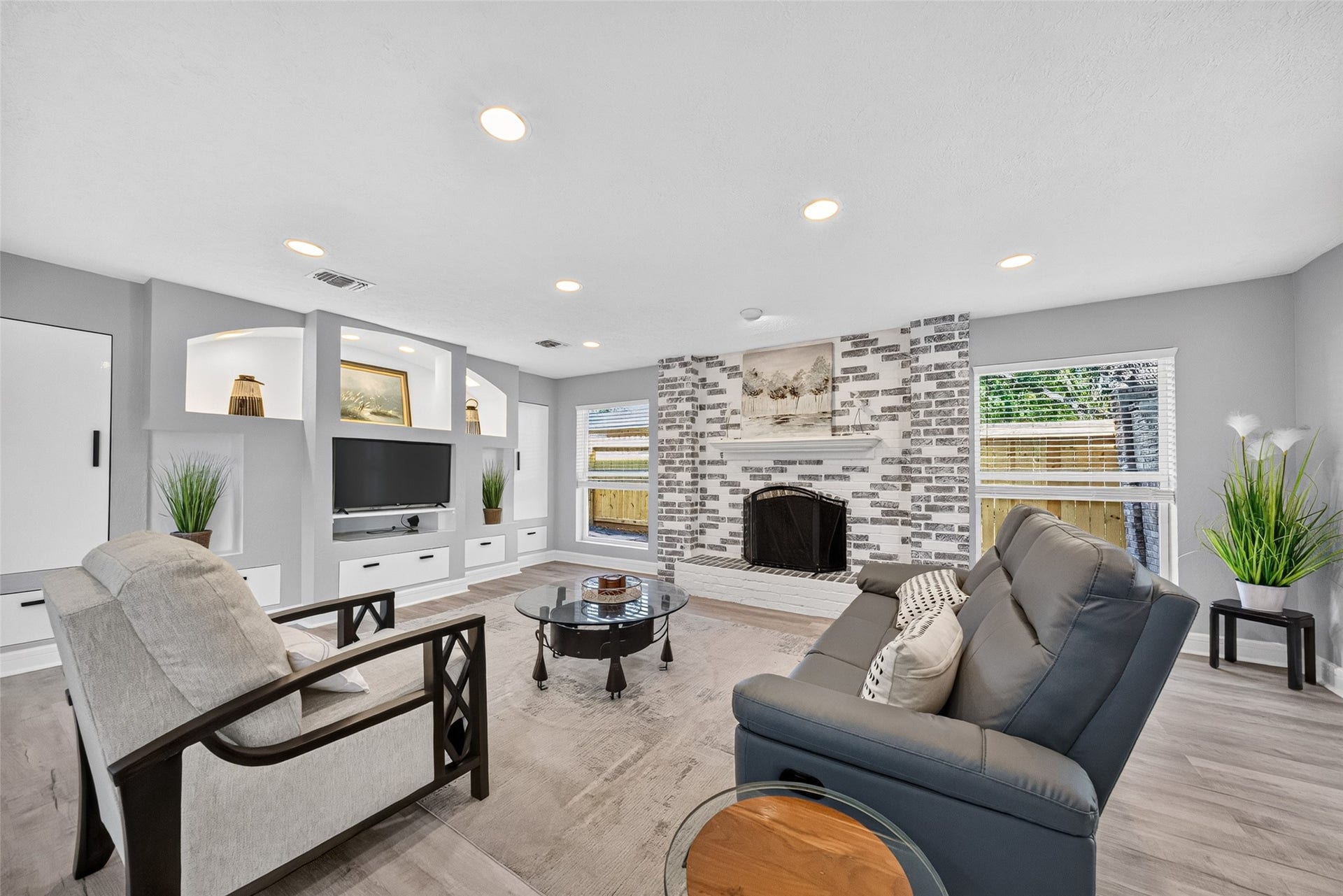 1003 Villa Court Drive, Seabrook, TX 77586 Inviting Family Room with Custom Built-Ins & Wood-Burning Fireplace.