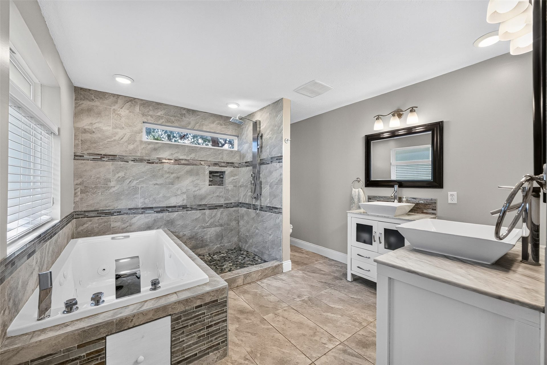 1003 Villa Court Drive, Seabrook, TX 77586 Spa-inspired primary bath featuring a jetted soaking tub, walk-in shower, and dual vanities.