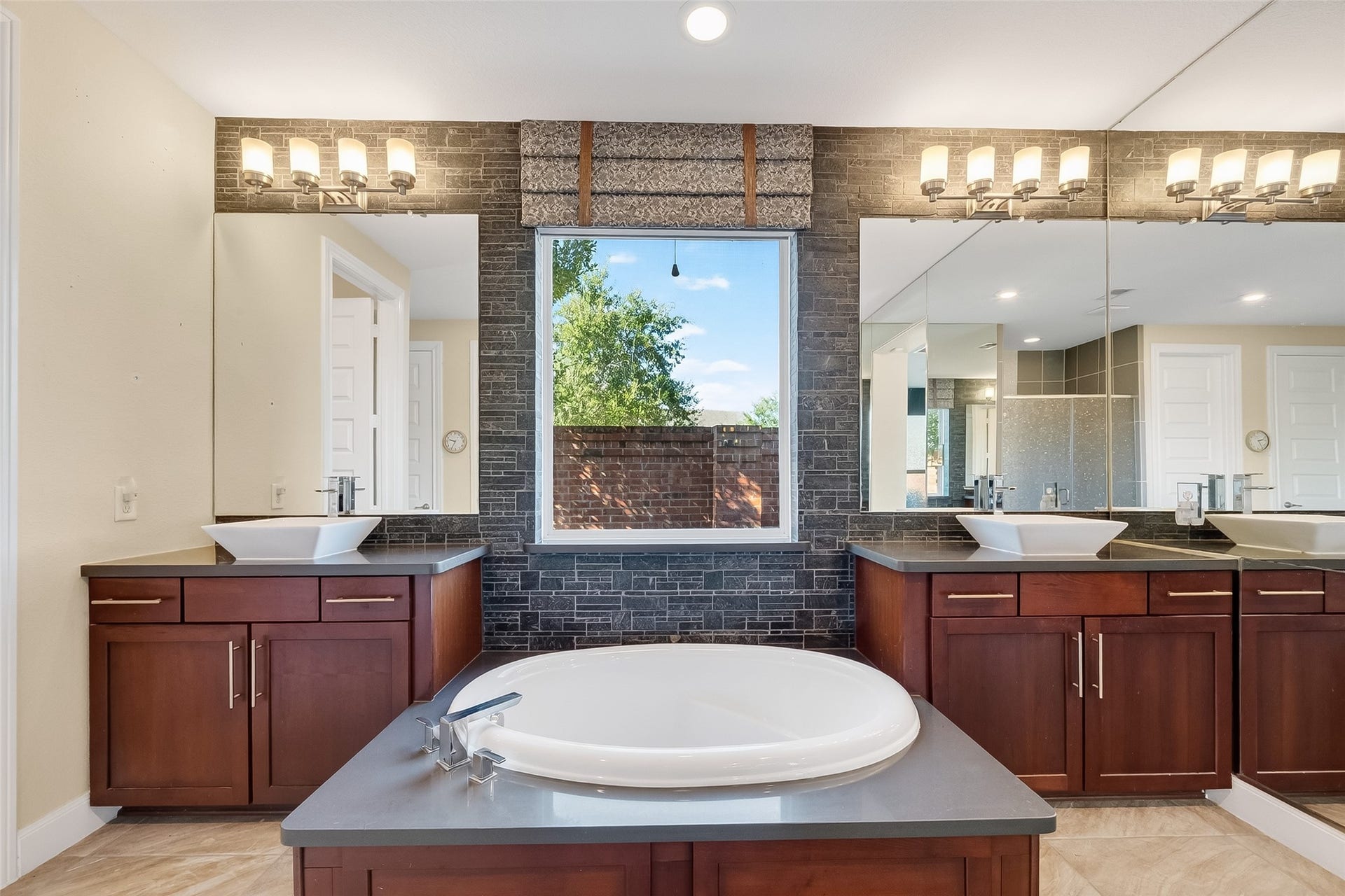 51 Scepter Ridge, Sugar Land, TX 77498 The Primary Bath features a soaking tub and dual vanity with vanity mount lavatories. Privacy wall just outside keeps any street noise out and lets plenty of sunlight in! It is designed for relaxing evenings and smooth morning routines.