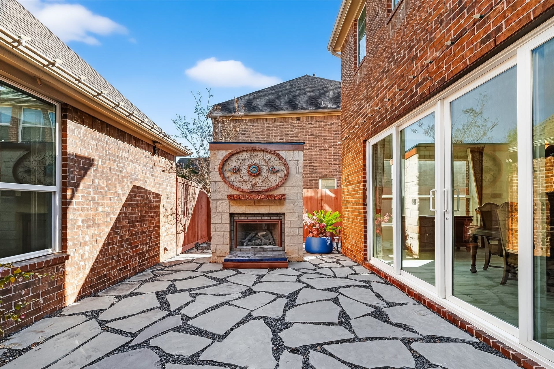 51 Scepter Ridge, Sugar Land, TX 77498 Another view of this rare gem of a space shows the stone patio where the outdoor gas log fireplace is the stand out feature. Imagine cozy evenings here with friends gathered around the fire.
