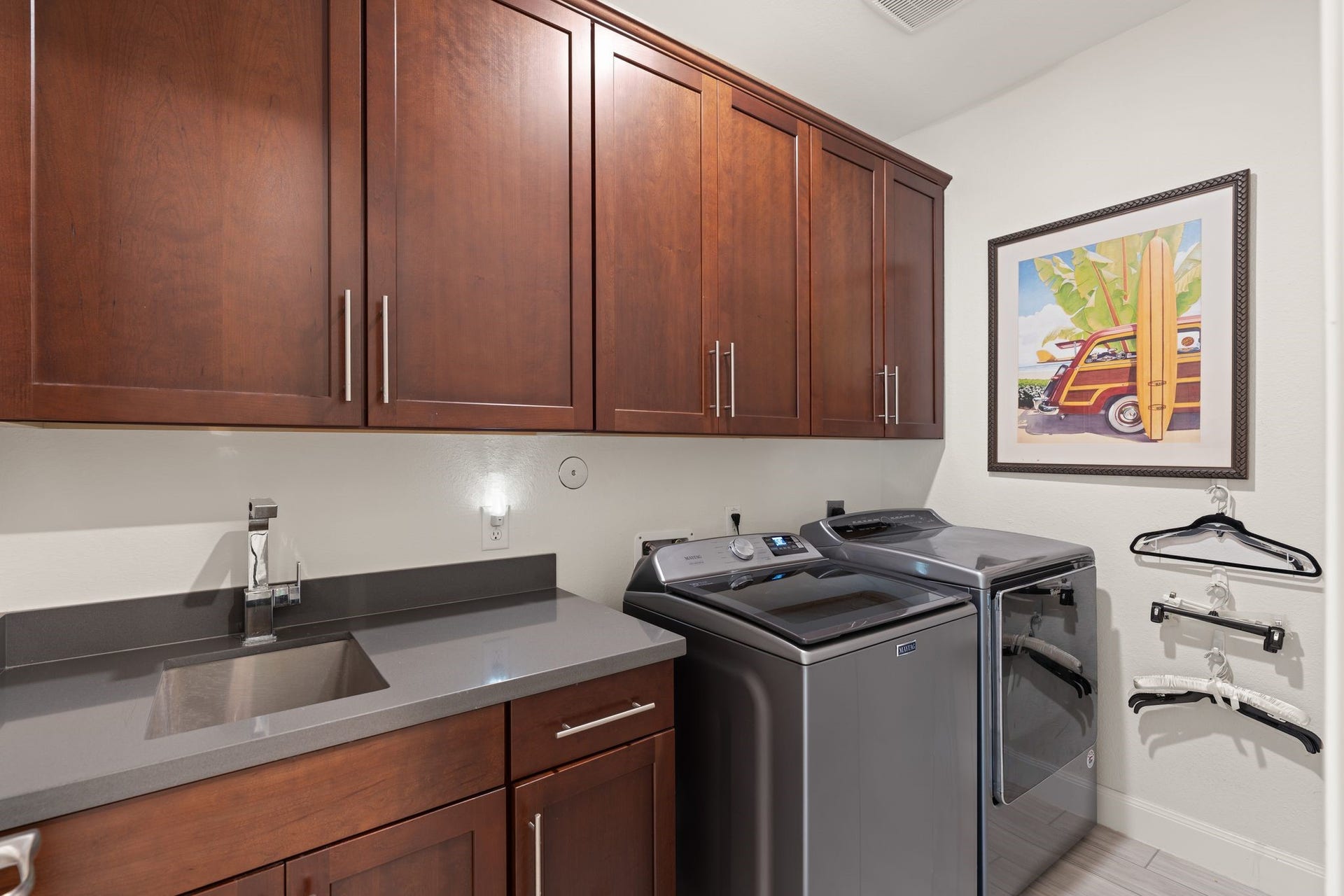 51 Scepter Ridge, Sugar Land, TX 77498 The laundry room keeps daily chores organized with cabinetry and counter space and undermount sink to make the tasks easier.