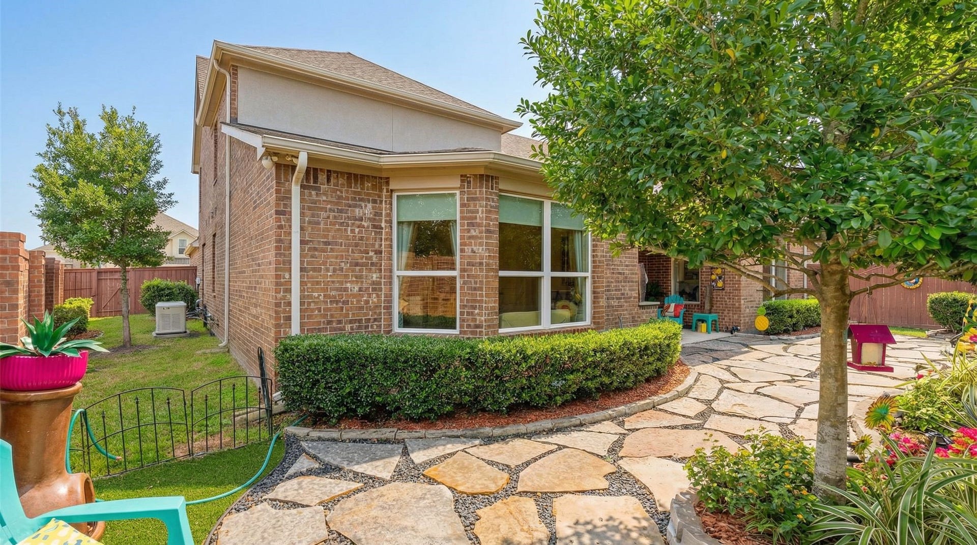 51 Scepter Ridge, Sugar Land, TX 77498 The back patio leads to the professionally landscaped yard fully equipped with a GENERATOR installed in 2021 and regularly maintained and serviced! Battery installed in 2026! Peace of mind knowing that the house is covered by a full house generator.