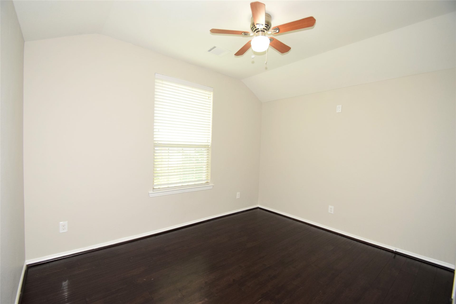 2nd bedroom complimented by hardwood floors, ceiling fan with light fixture, raised ceilings, window blinds and nice closet space.