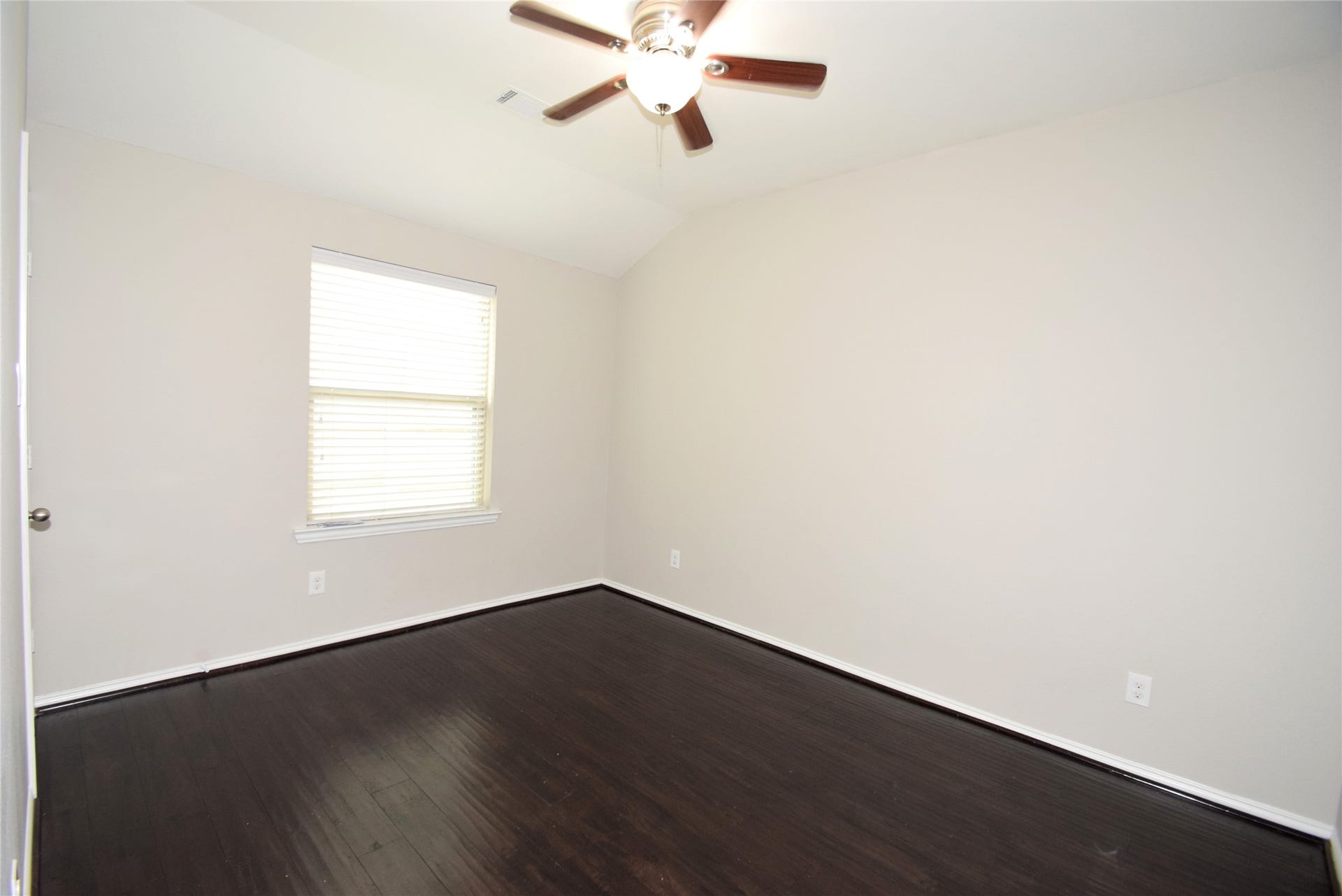 3rd bedroom complimented by hardwood floors, ceiling fan with light fixture, raised ceilings, window blinds and nice closet space.