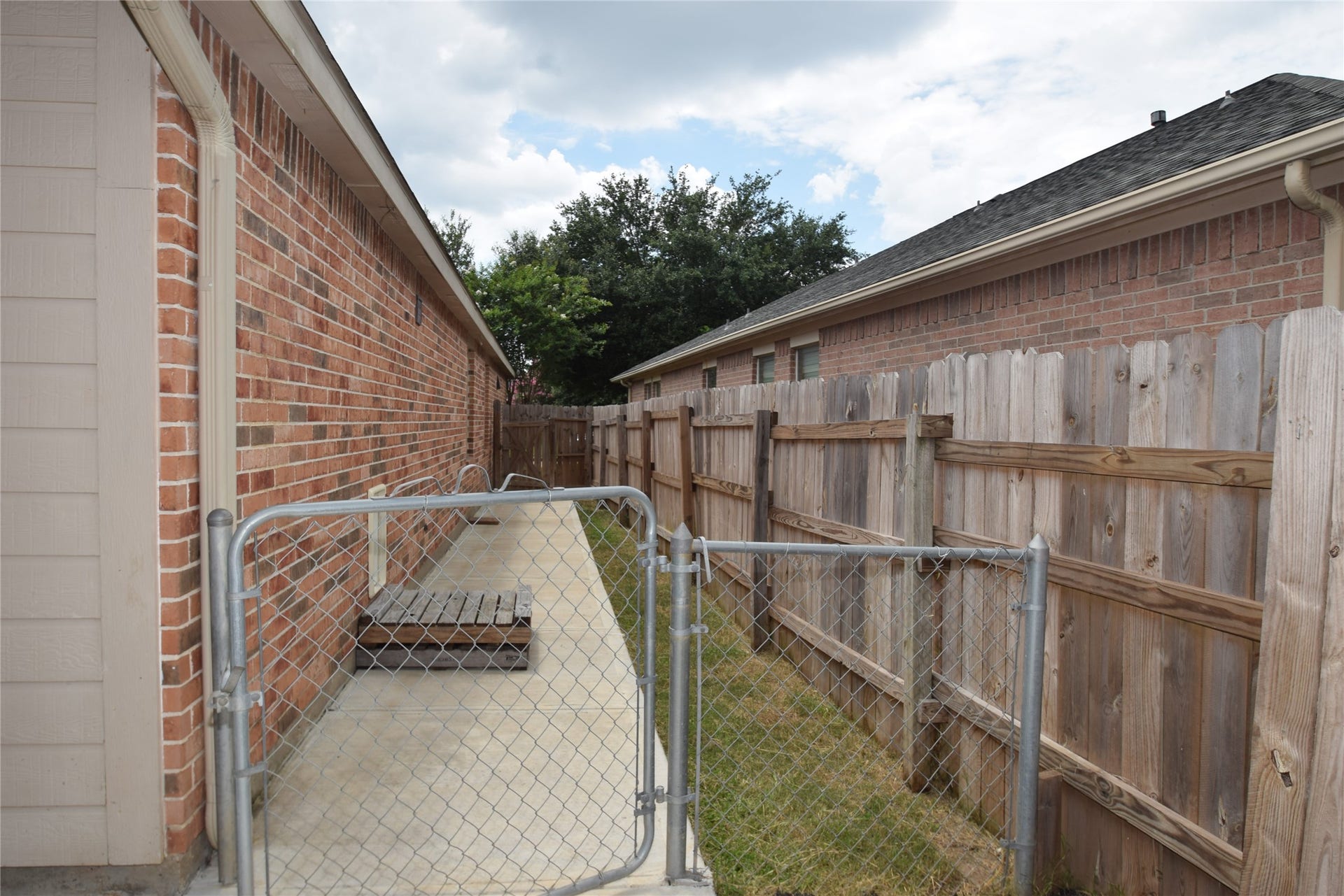 Side yard with a dog run area.