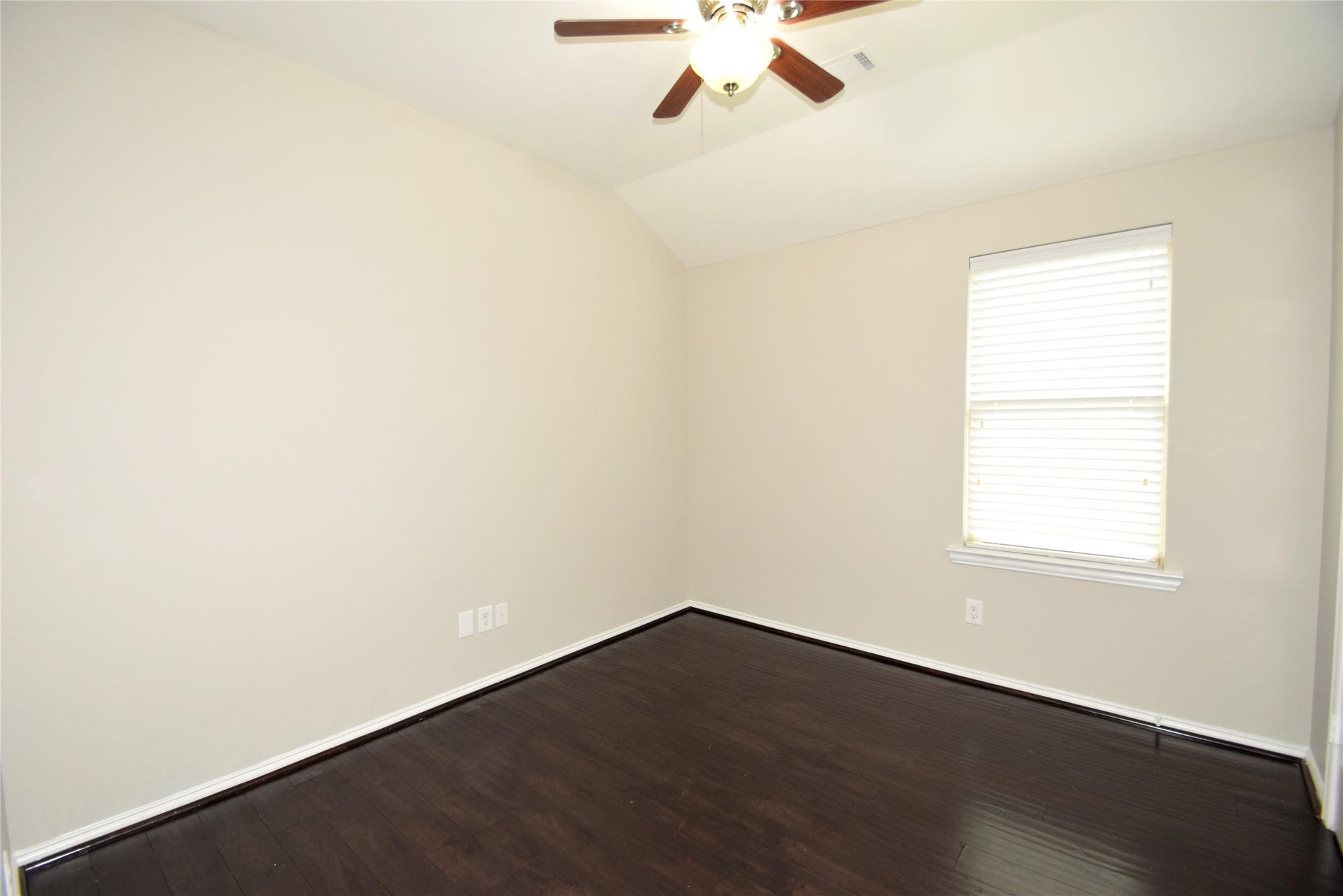 4th bedroom complimented by hardwood floors, ceiling fan with light fixture, raised ceilings, window blinds and nice closet space.