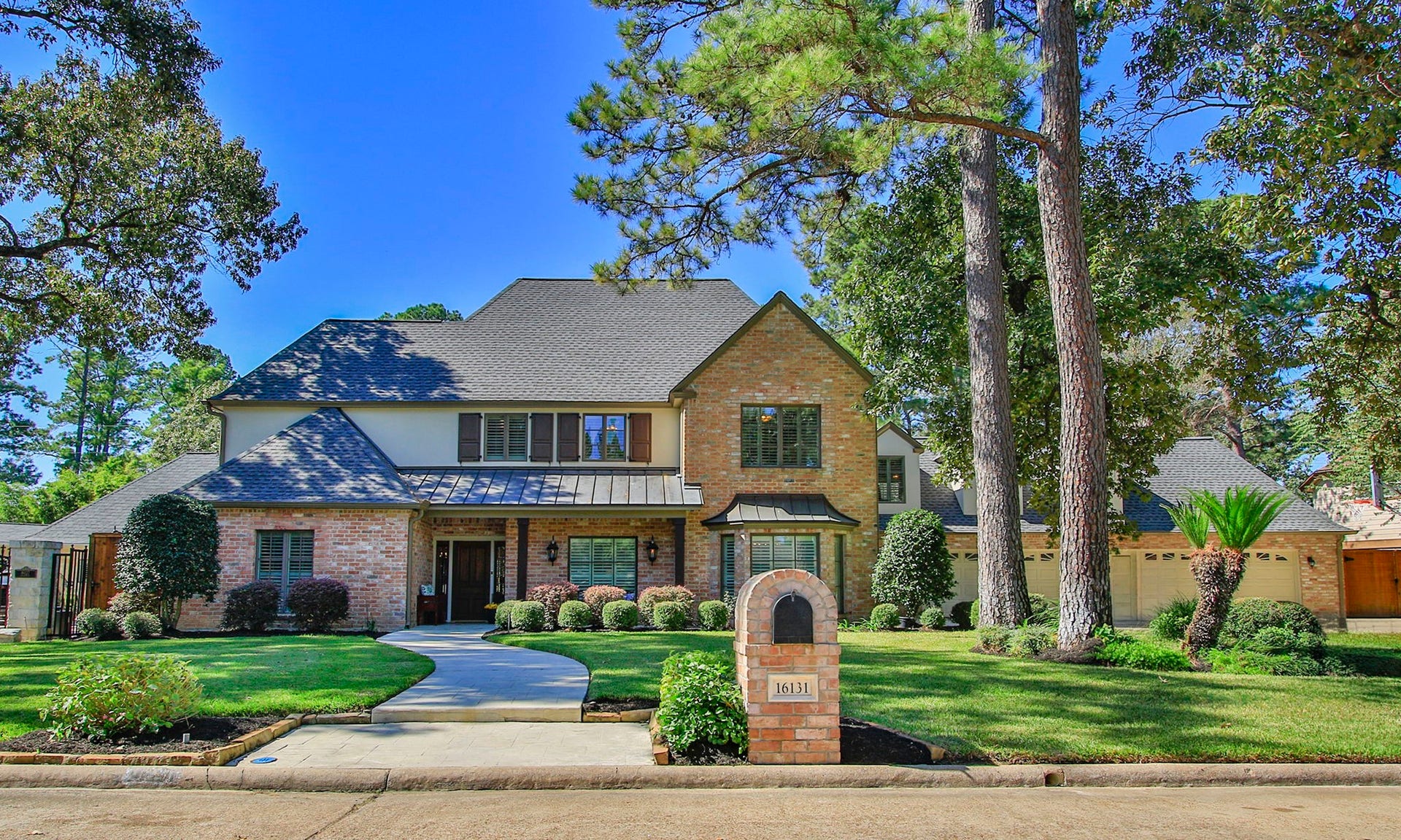 16131 Rudgewick Lane, Spring, TX 77379 Stunning traditional home in the heart of Champion Forest - with timeless curb appeal, beautiful brick architecture, elegant rooflines, and a welcoming covered front porch.
