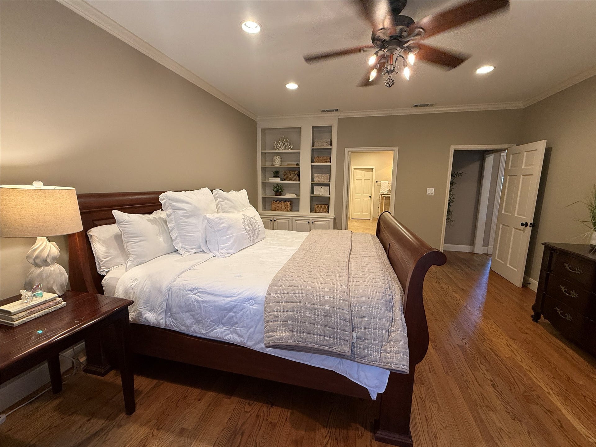 16131 Rudgewick Lane, Spring, TX 77379 Primary bedroom with hard wood floors and built in shelves.