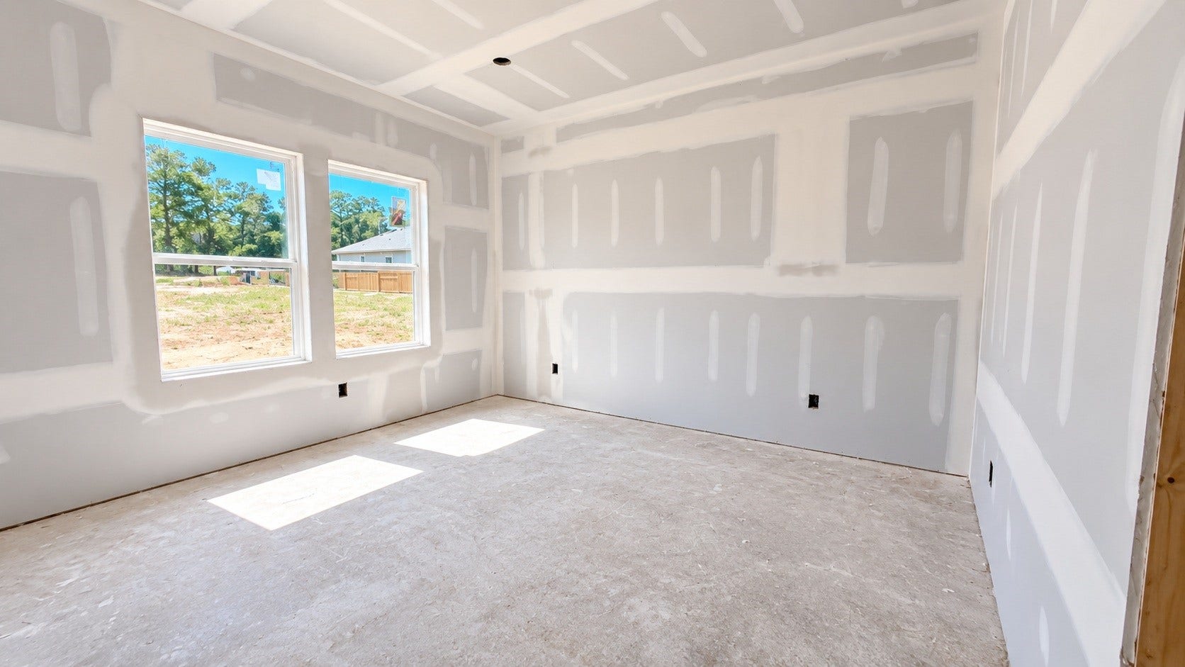 Large, energy-efficient windows invite natural light to fill the room, enhancing the airy, open feel while preserving privacy.