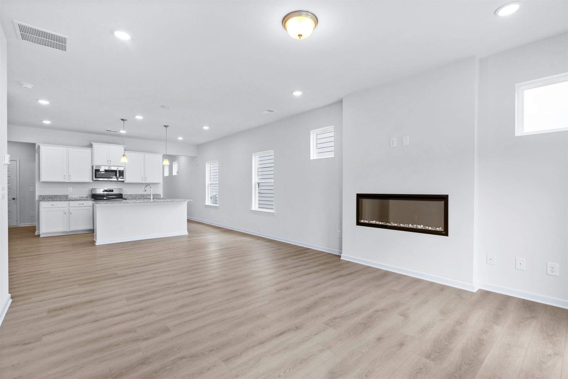21835 Cypress Vine Drive, Splendora, TX 77372 The Dove- Family Room into the Kitchen. Home under construction, photo used for illustrative purposes only, colors and options will vary.