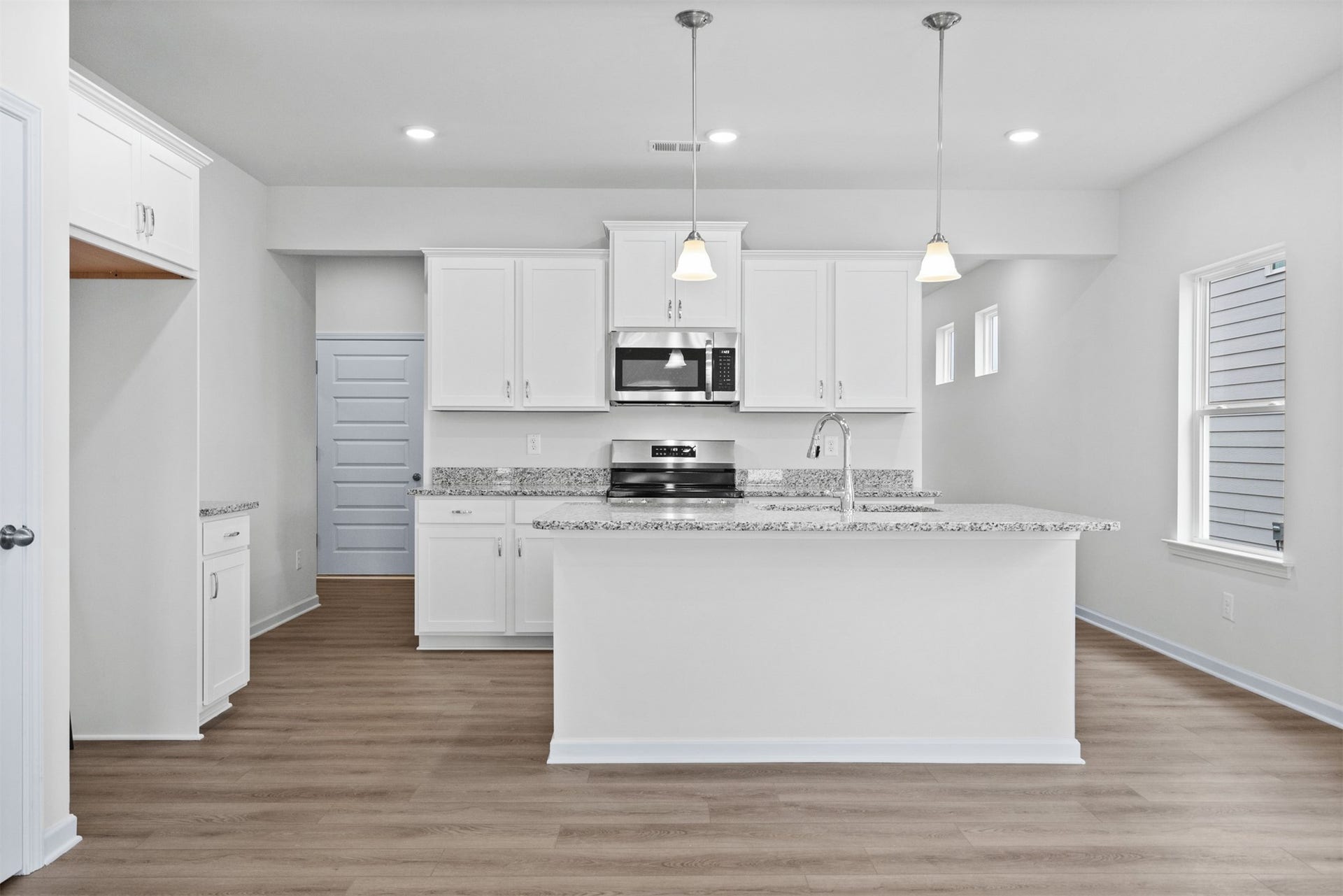 21835 Cypress Vine Drive, Splendora, TX 77372 The Dove- Kitchen with Island. Home under construction, photo used for illustrative purposes only, colors and options will vary.
