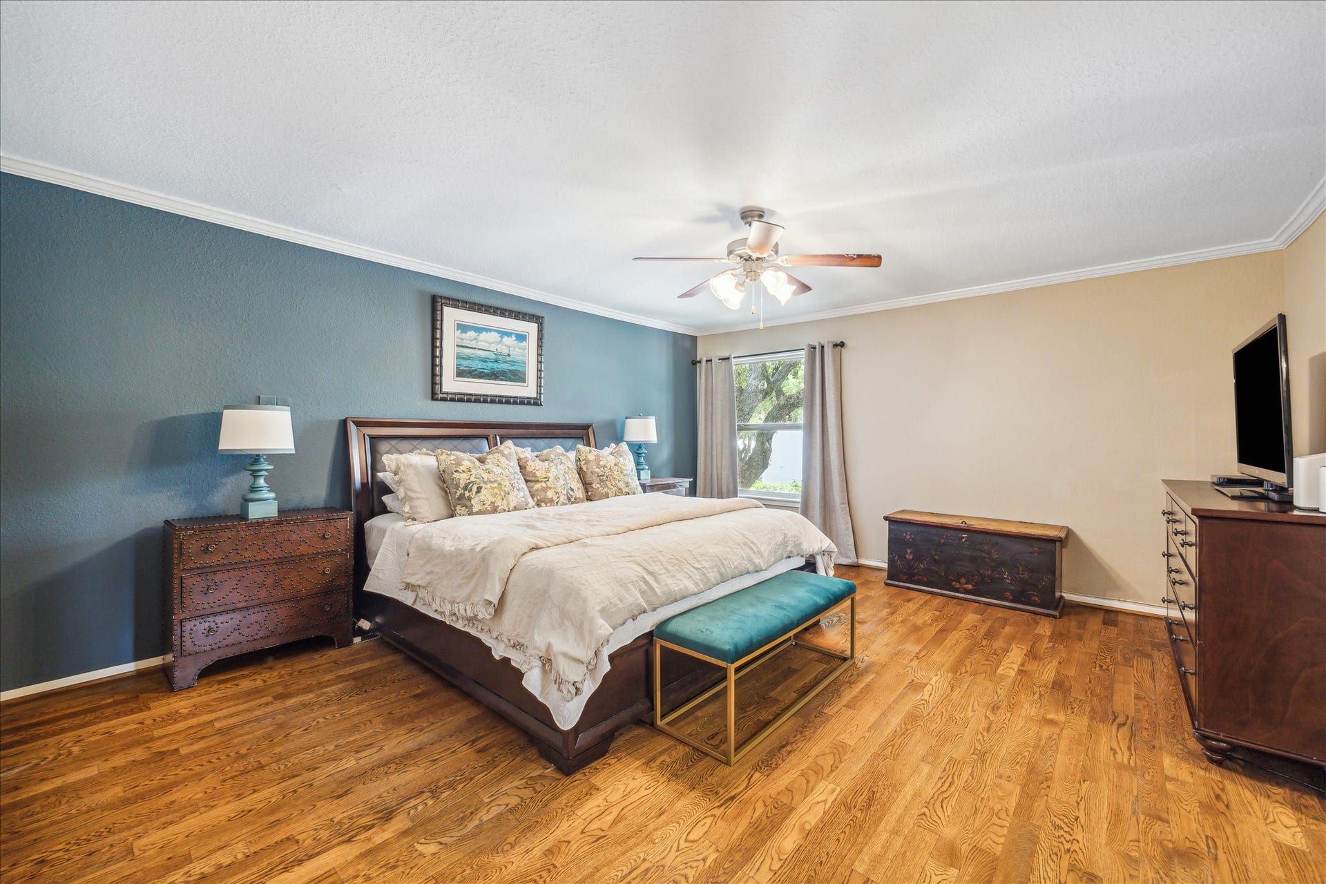 Spacious primary bedroom with hardwood floors and fabulous closet space!