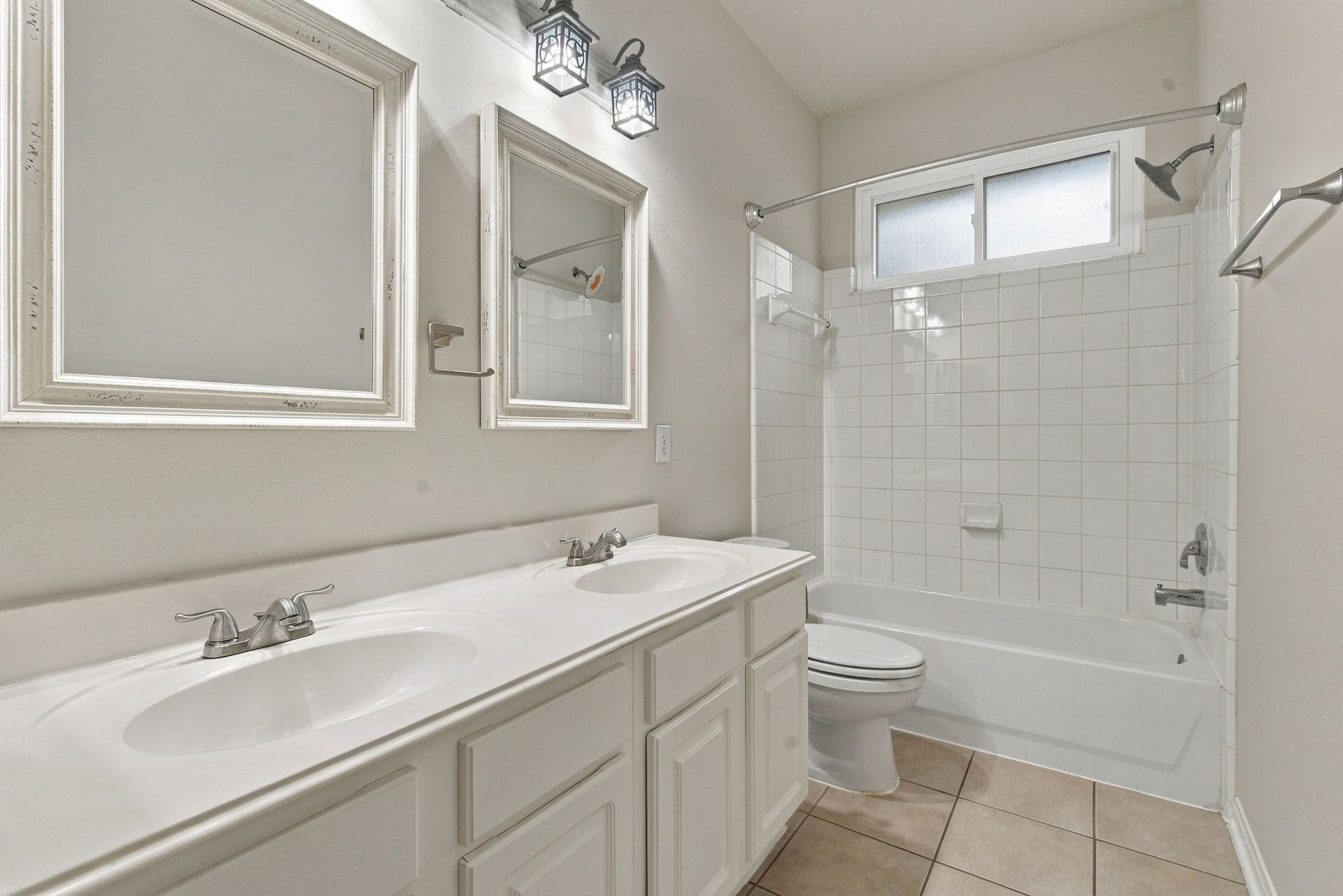 12843 Sherlock Acres Drive, Tomball, TX 77377 View of the downstairs full bath off the secondary bedrooms with dual sinks and a combination tub and shower.