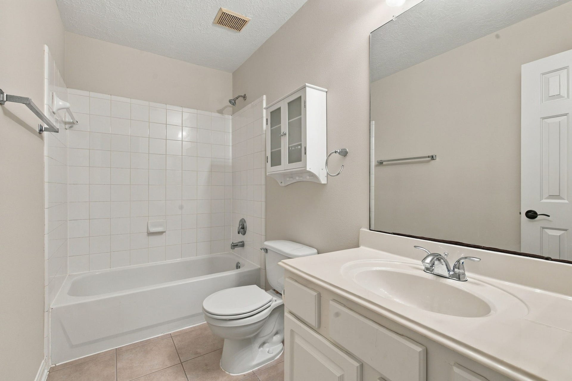 12843 Sherlock Acres Drive, Tomball, TX 77377 View of the upstairs bathroom with a combination tub and shower.