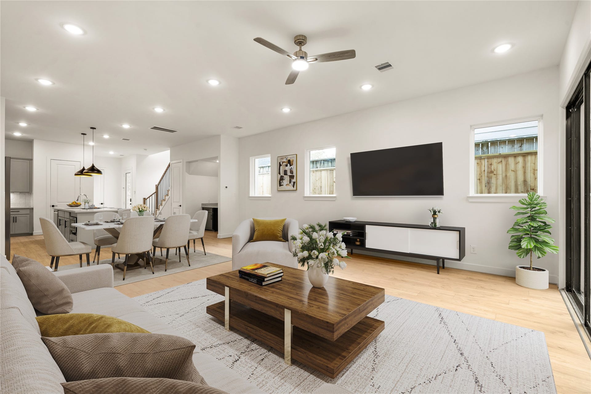 5018 Schuler Street, Houston, TX 77007 Spacious entertainer's lounge low-profile coffee table, wall-mounted media center, natural light from surrounding windows, and effortless connection to the dining and kitchen quarters.