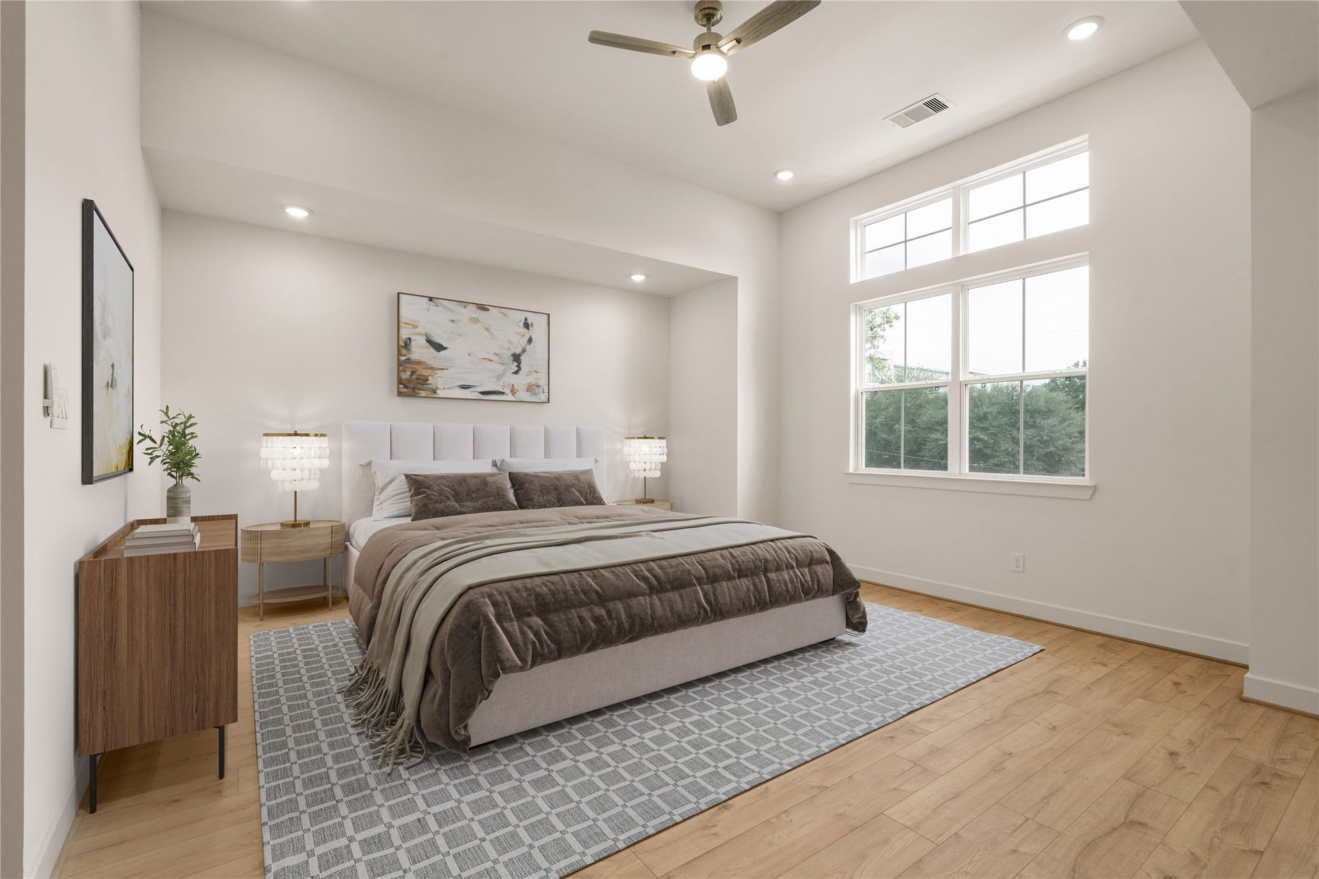 5018 Schuler Street, Houston, TX 77007 Primary bedroom retreat tufted upholstered bed, high architectural ceiling with transom windows streaming morning light, sleek wooden dresser, and modern ceiling fan.