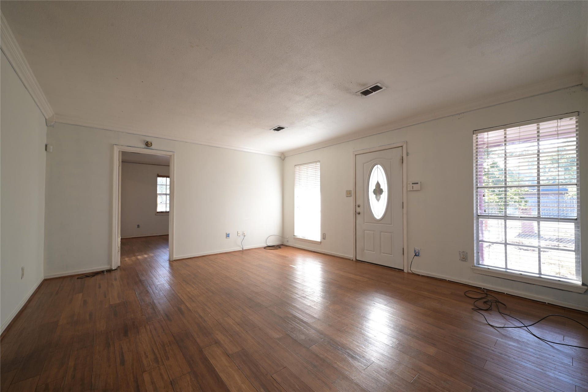 Sun filled living space with warm hardwood floors