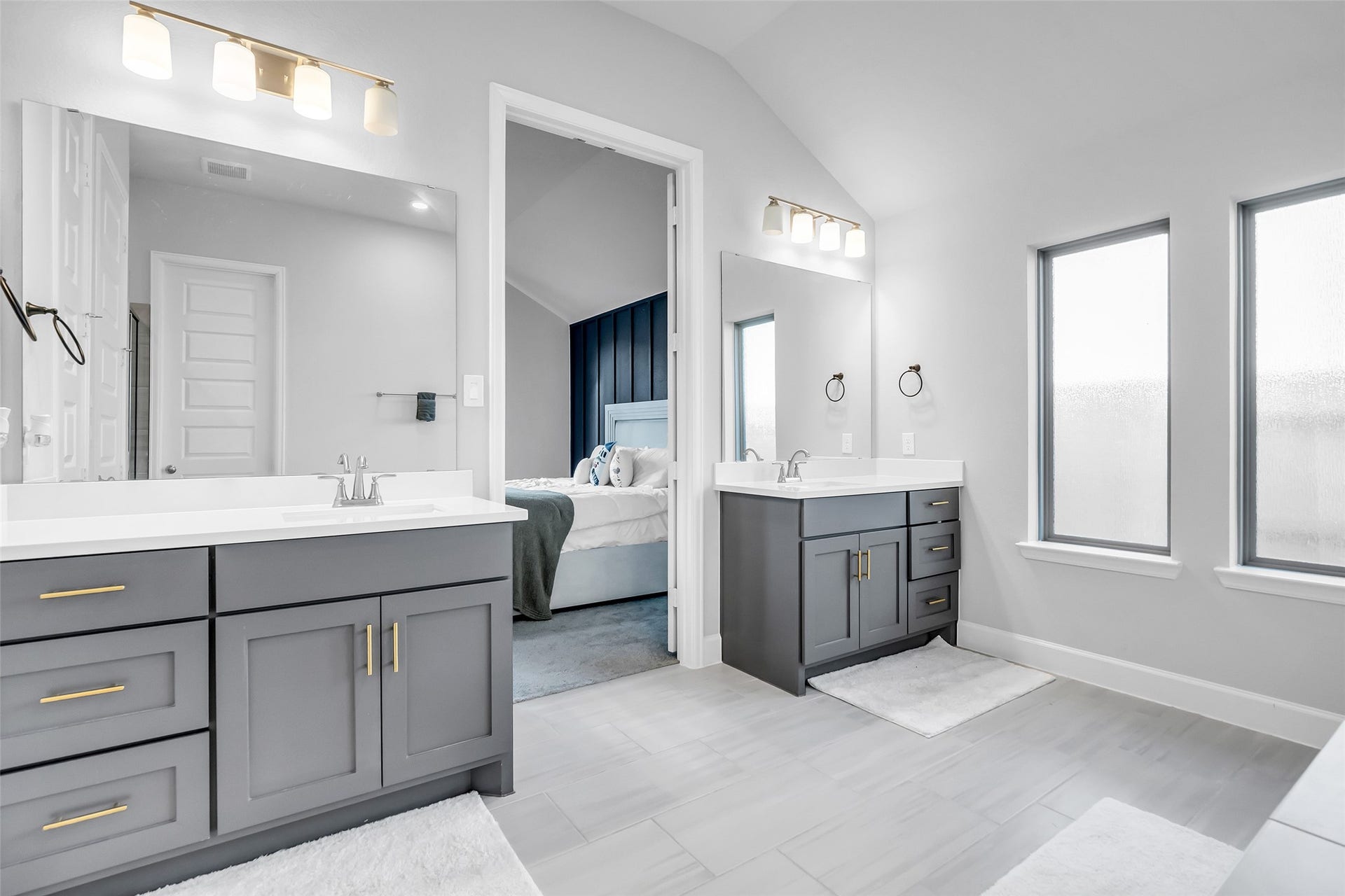 30047 Gold Finch Place, Fulshear, TX 77441 Get Prepared In Style w/ Your Dual Vanities, Sleek Gray Cabinetry, & Modern Light Fixtures. Abundant Natural Light Streams Through Frosted Windows, Creating A Serene & Inviting Atmosphere.
