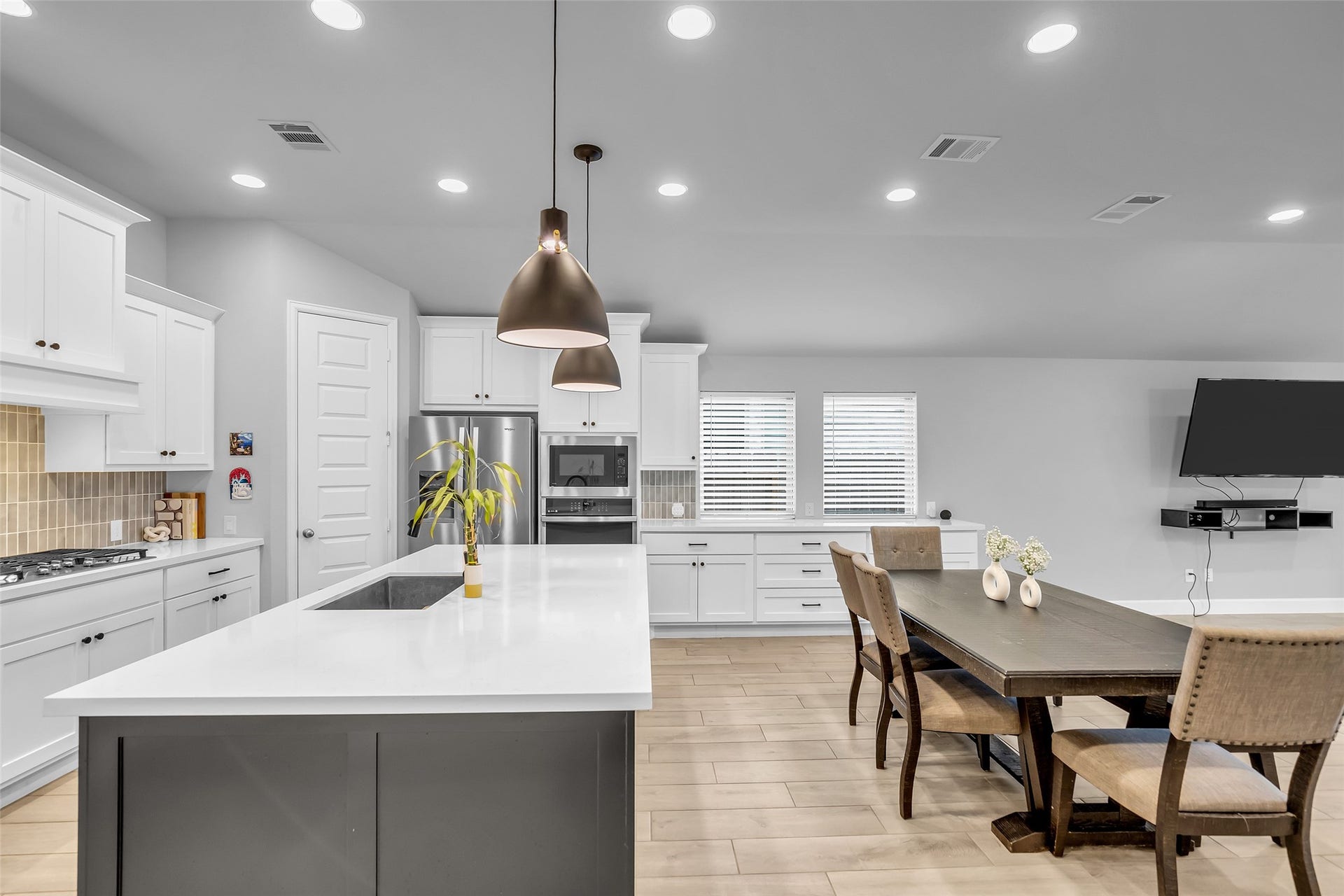 30047 Gold Finch Place, Fulshear, TX 77441 Discover Your Modern Kitchen Featuring Sleek, White Cabinetry, A Spacious Island w/ Sink, & In-Ceiling Lighting. The Open Layout Seamlessly Connects To A Cozy, Dining Area w/ Long Buffet, Perfect For Entertaining!Gas