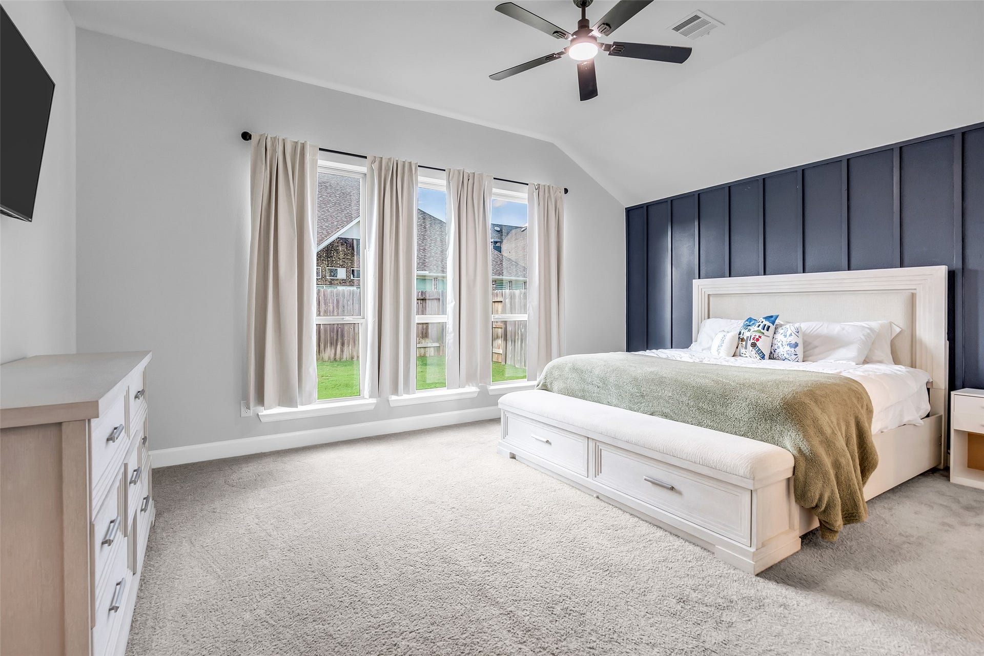 30047 Gold Finch Place, Fulshear, TX 77441 Your Primary Retreat Featuring Tall Ceilings, Elegant Accent Wall, & Large Windows Providing An Abundance of Natural Light.