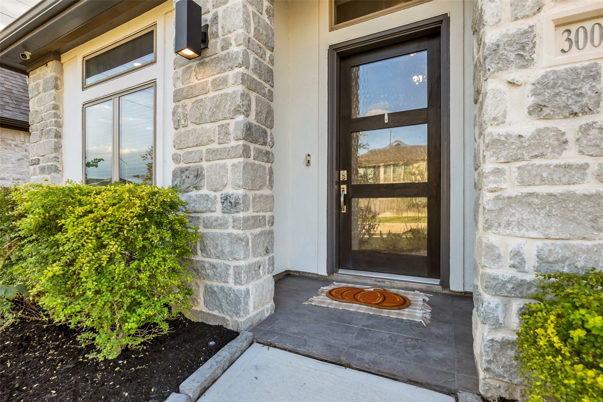 30047 Gold Finch Place, Fulshear, TX 77441 Charming Stonework Grace Your Entryway Along w/ A Sleek, Modern Door, Framed By Lush Greenery For A Welcoming First Impression.