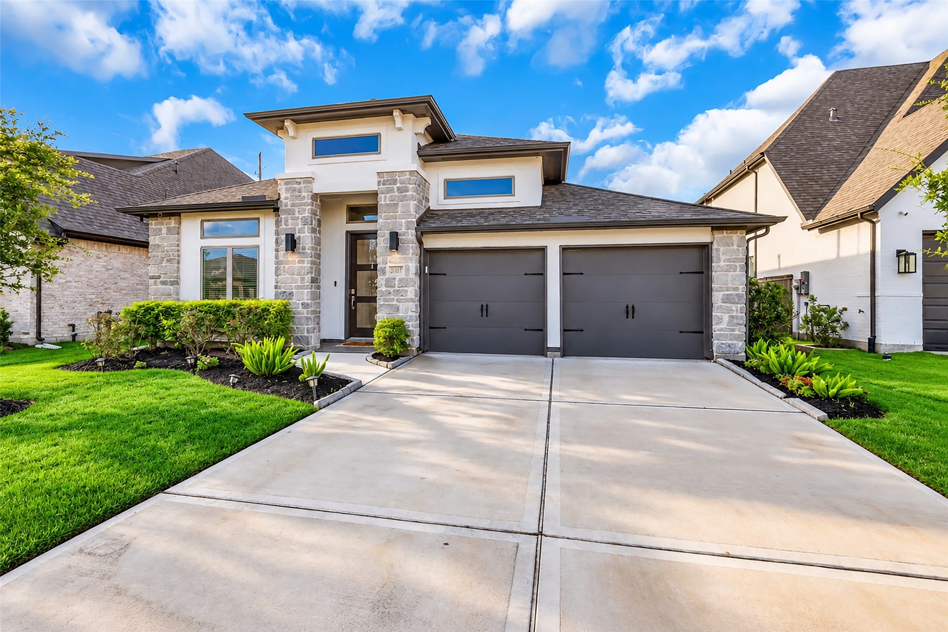30047 Gold Finch Place, Fulshear, TX 77441 Your Stunning, Modern Home w/ Dual Garage, Elegant Stone Accents, & Lush Landscaping On A Spacious, Double-Wide Driveway.