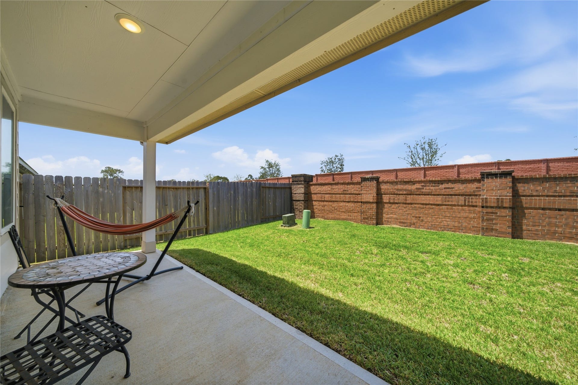 1206 Ricasoli Drive, Richmond, TX 77406 A covered patio in a private back yard.