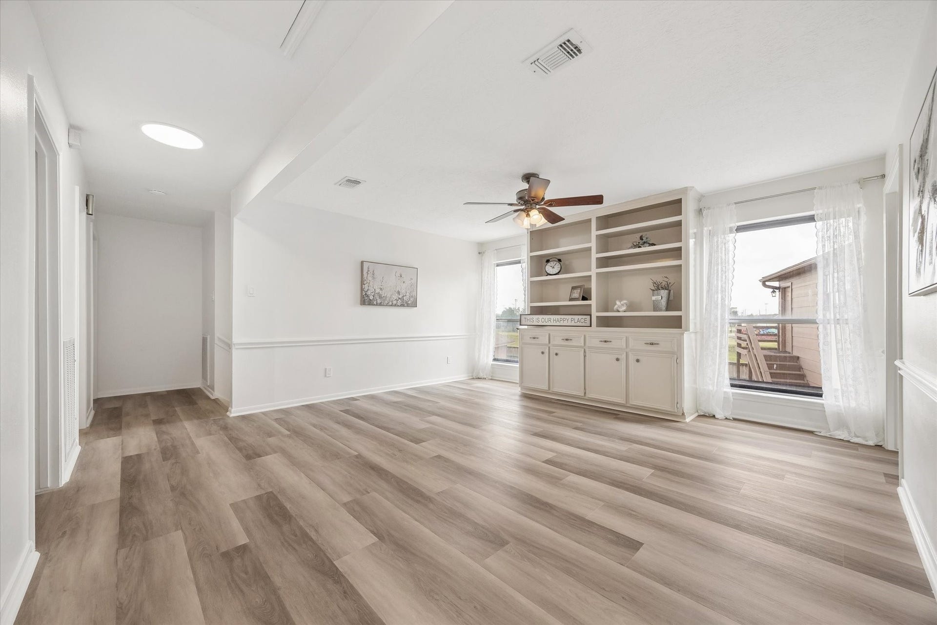 110 Shadow Wood Drive, Sugar Land, TX 77498 Bright, airy, versatile game room upstairs with new commercial LVP flooring, built-in shelving, and large windows.