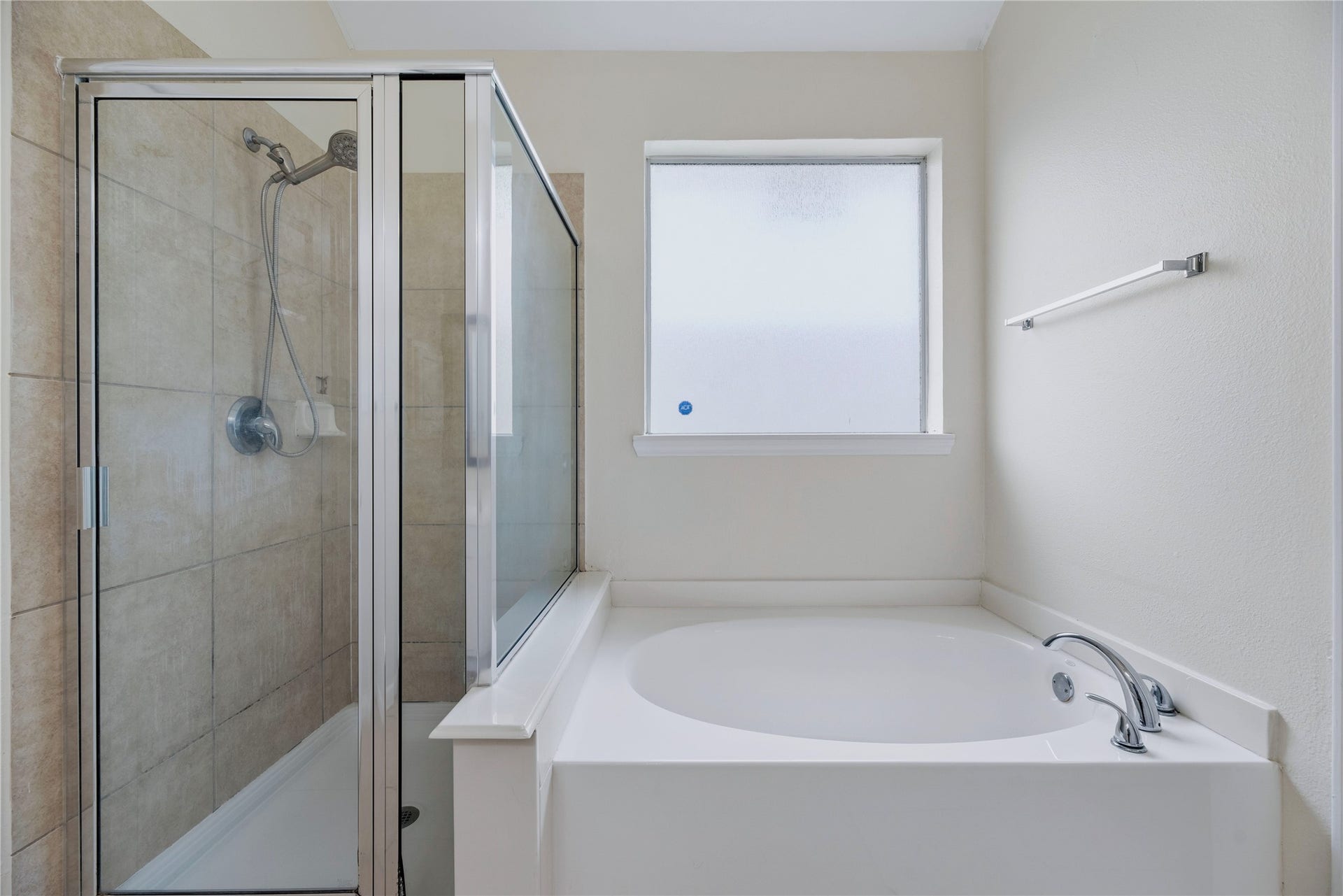 The primary bath offers a separate tub and enclosed shower, giving you a choice for the daily routine without combining both into one fixture.