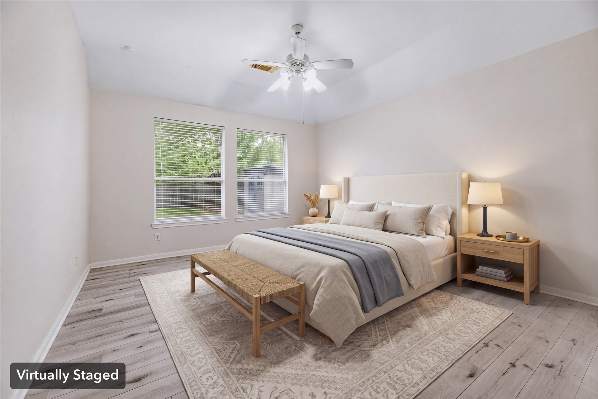 Virtually staged to show a restful bedroom arrangement, with rear windows and a ceiling fan above. Furniture shown is digital.