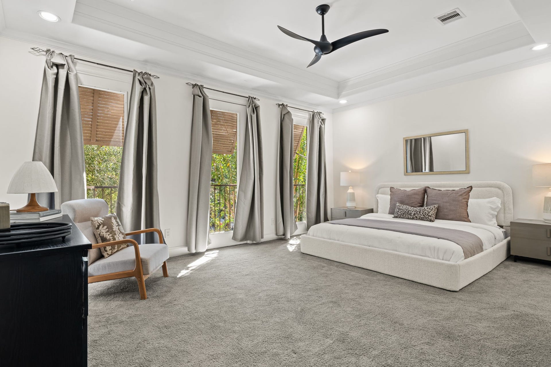 The primary bedroom is generously proportioned and filled with natural light from multiple windows. Soft neutral finishes create a serene foundation for a private retreat.