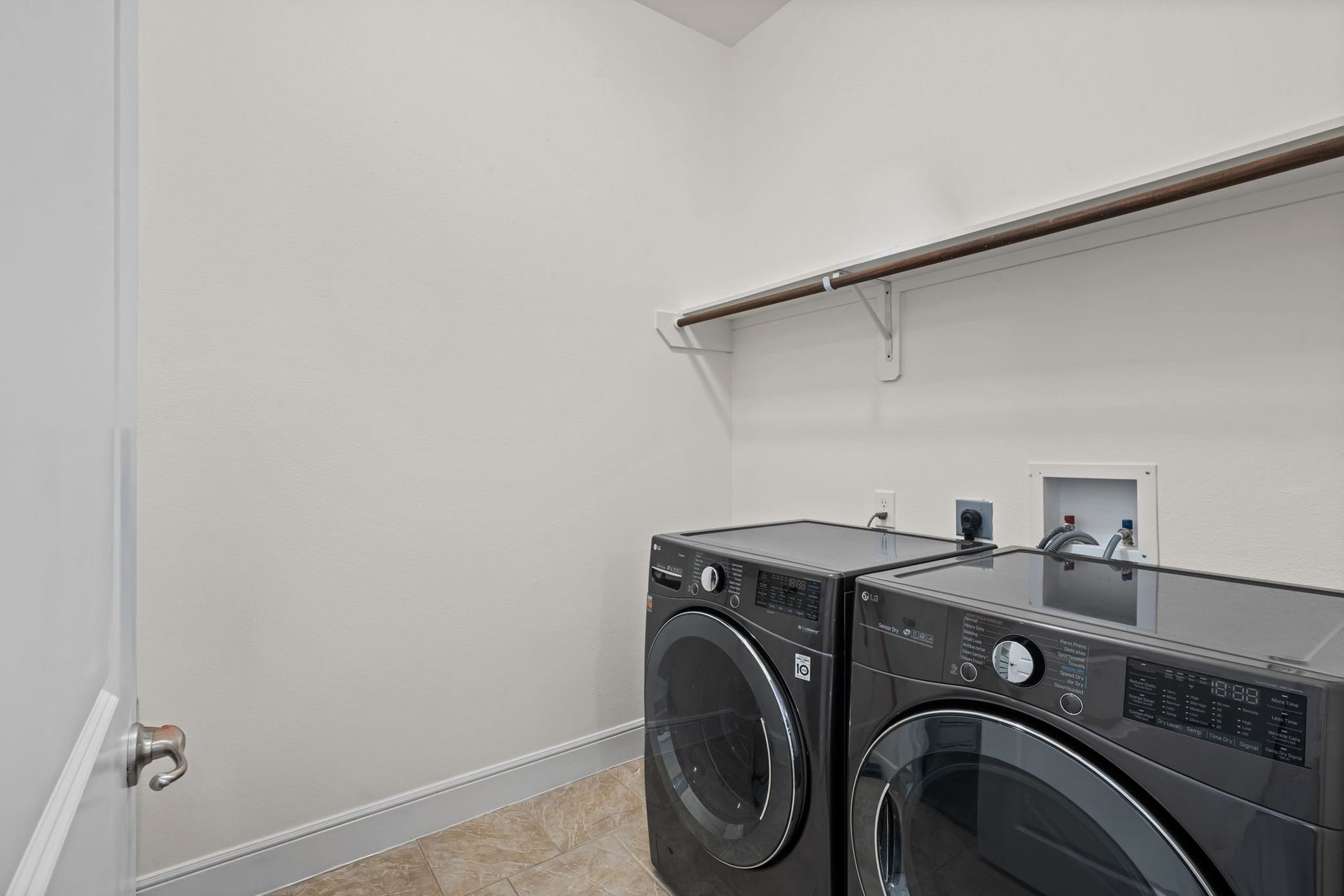 A dedicated second-floor laundry room keeps household tasks conveniently close to the bedrooms. Built-in storage and side-by-side connections support practical organization.