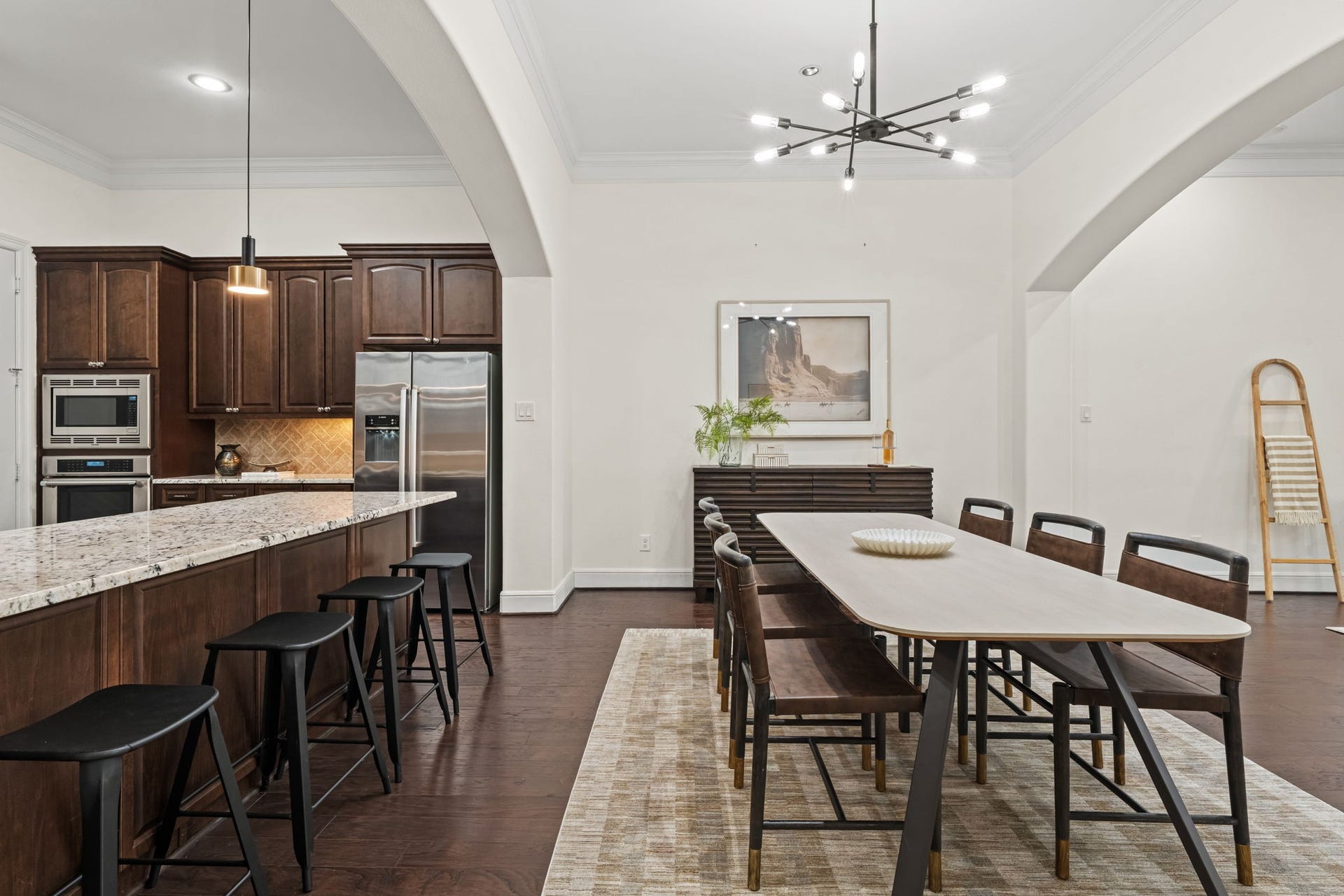 The well-appointed kitchen opens naturally to the dining area for an effortless everyday flow. Rich cabinetry, expansive counters, and a substantial island balance warmth with modern function.