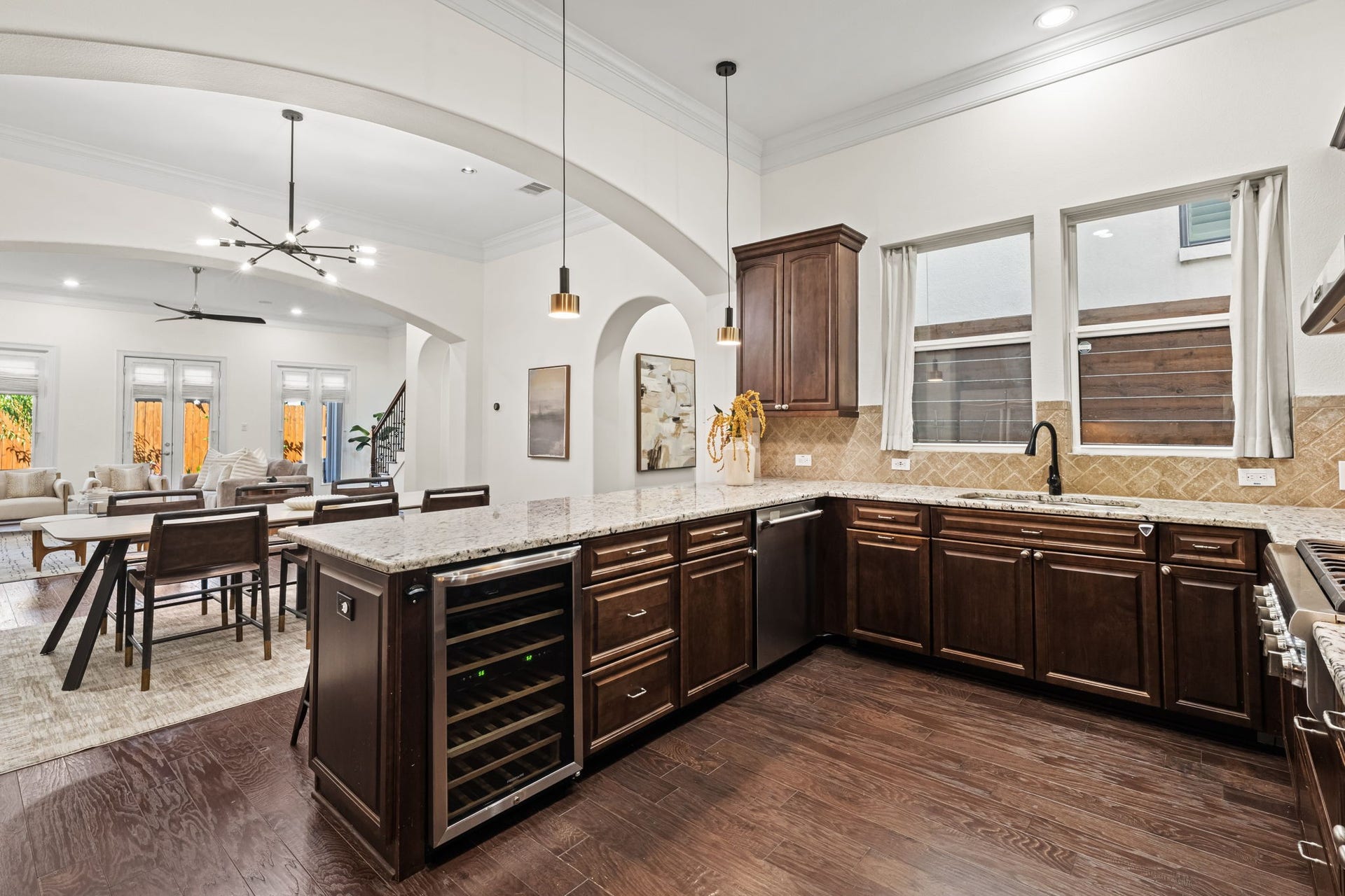 This alternate kitchen view highlights the broad island and easy circulation throughout the first floor. The open configuration allows dining and living areas to feel connected yet individually defined.