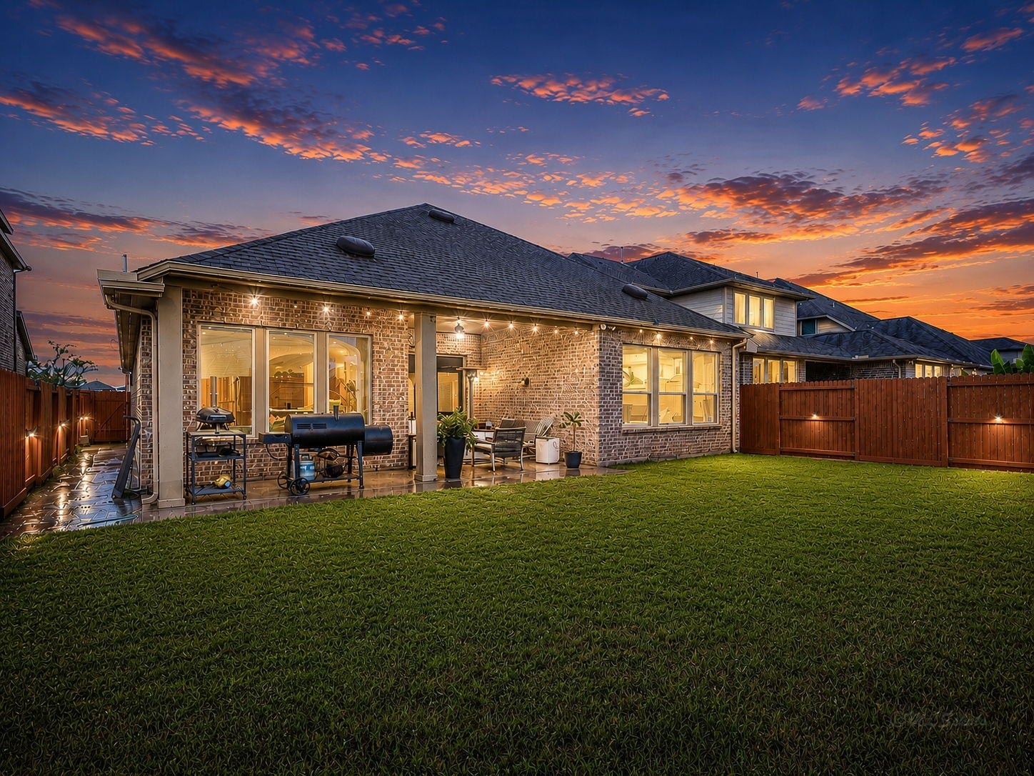 Spacious backyard and EXTENDED covered patio. Interior of fence is beautifully stained and accented with solar fence lights. The nighttime twinkle view is perfection!