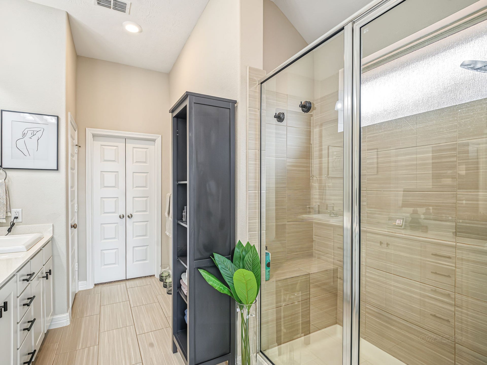 Oversized shower with built-in bench creates a luxe feel.