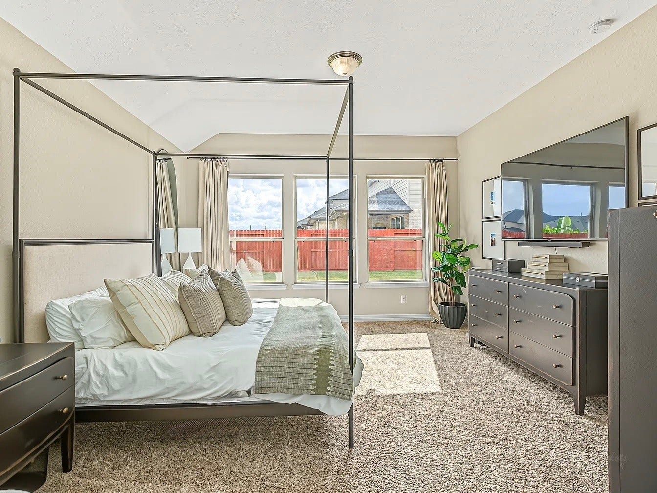 The owners' retreat is simply spectacular! Window views to the backyard create a warm and relaxing vibe.