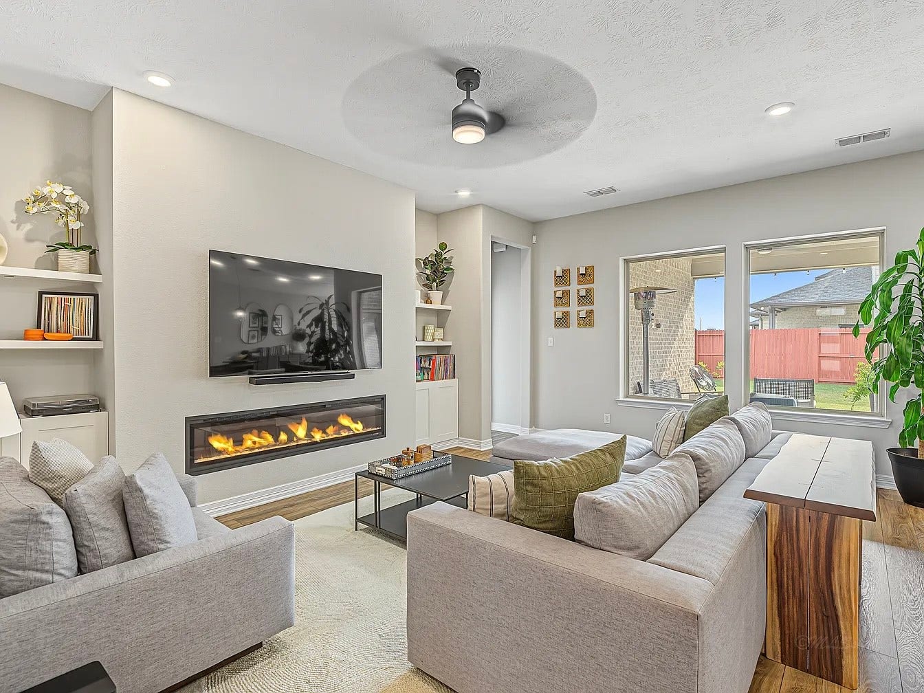 From the entry corridor, step into the great room! The built-in electric fireplace offers luxury vibes in the living space.
