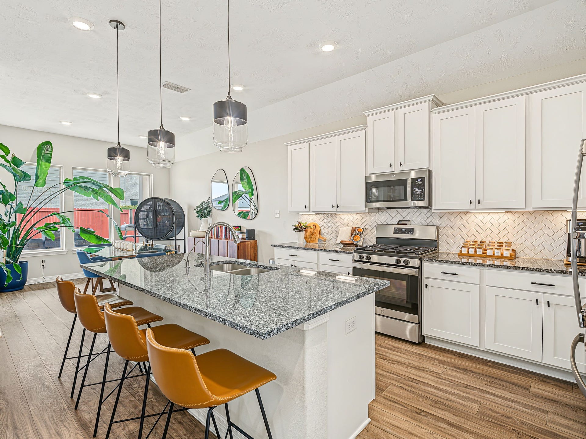 The adjacent casual dining flows seamlessly to the kitchen. You will FALL in love with this open concept space. So incredibly light and bright!