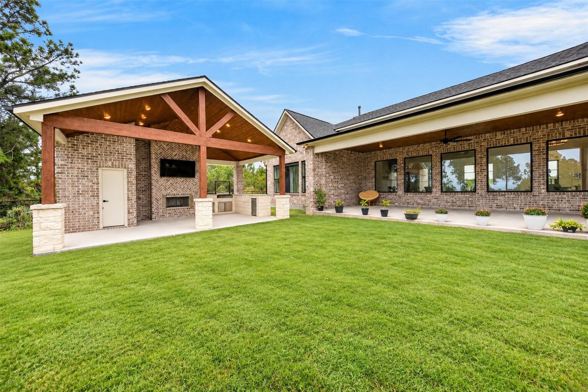 35851 Pineridge Road, Waller, TX 77484 The brick rear elevation, covered pavilion, and broad lawn come together to extend the home's living space outdoors.