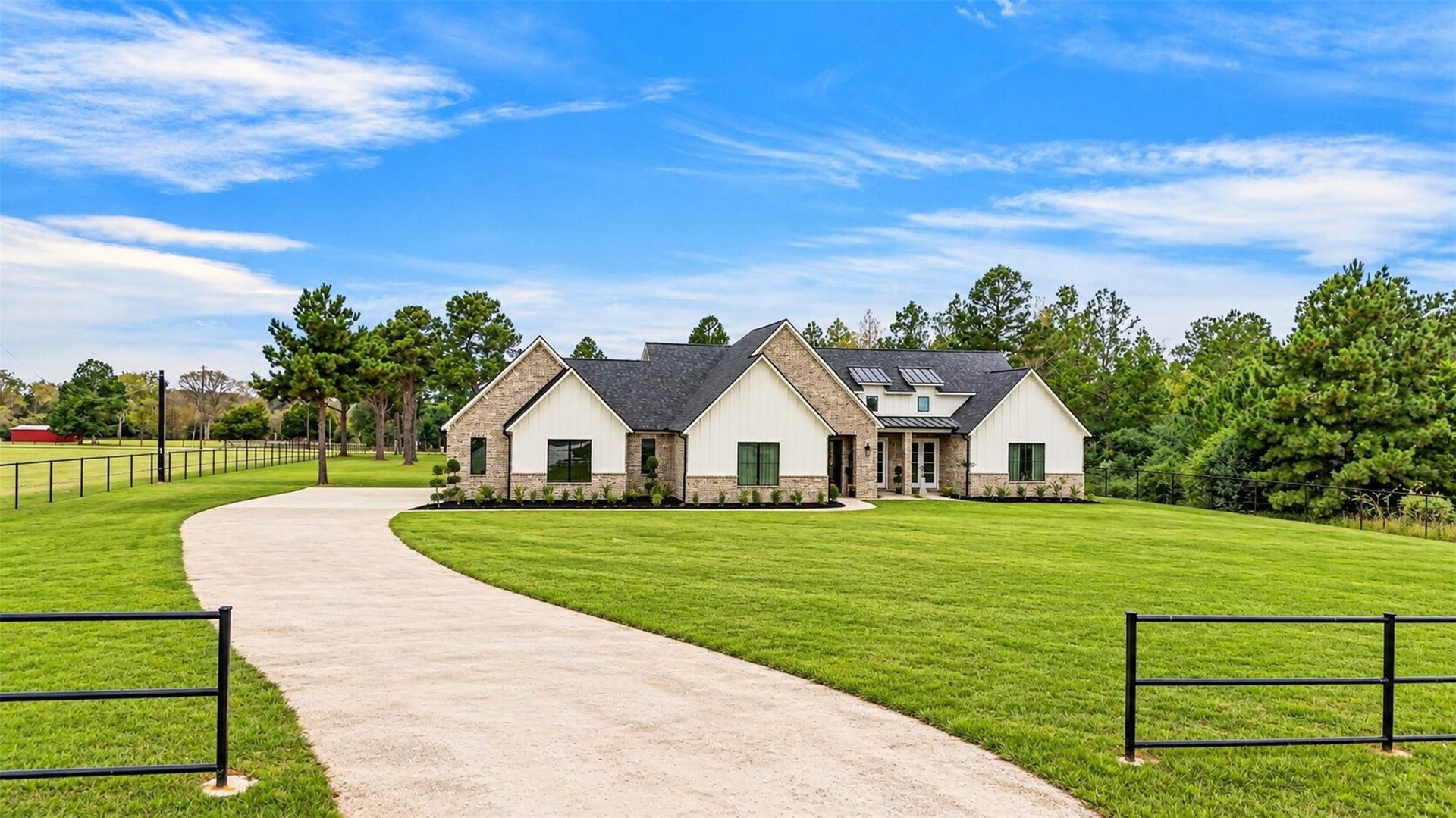 35851 Pineridge Road, Waller, TX 77484 A curved concrete drive leads to the brick garage wing, where varied rooflines add architectural interest to the home's approach.