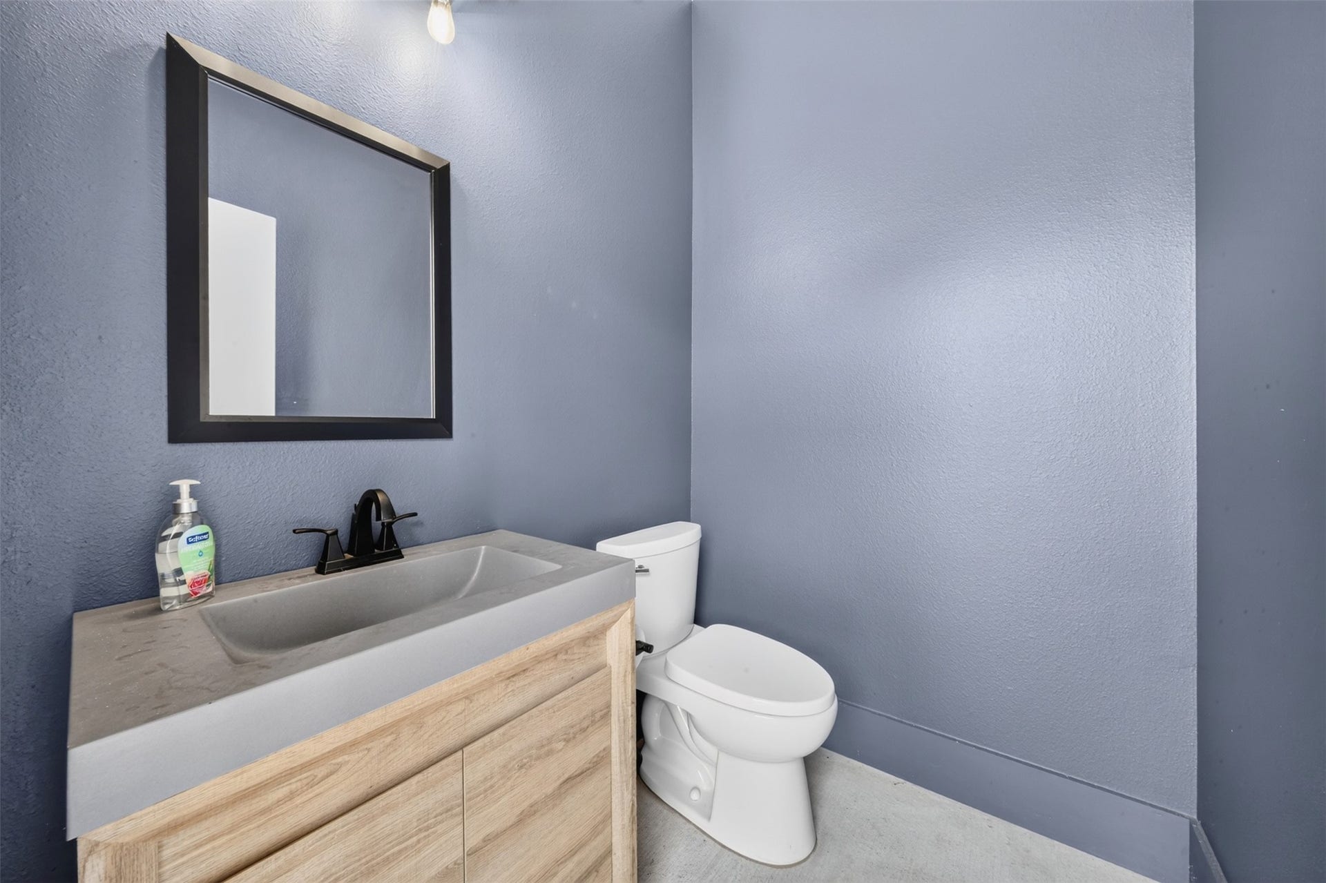 35851 Pineridge Road, Waller, TX 77484 Blue-gray walls and a light wood vanity bring color and warmth to the powder bath while keeping the finishes simple and clean.