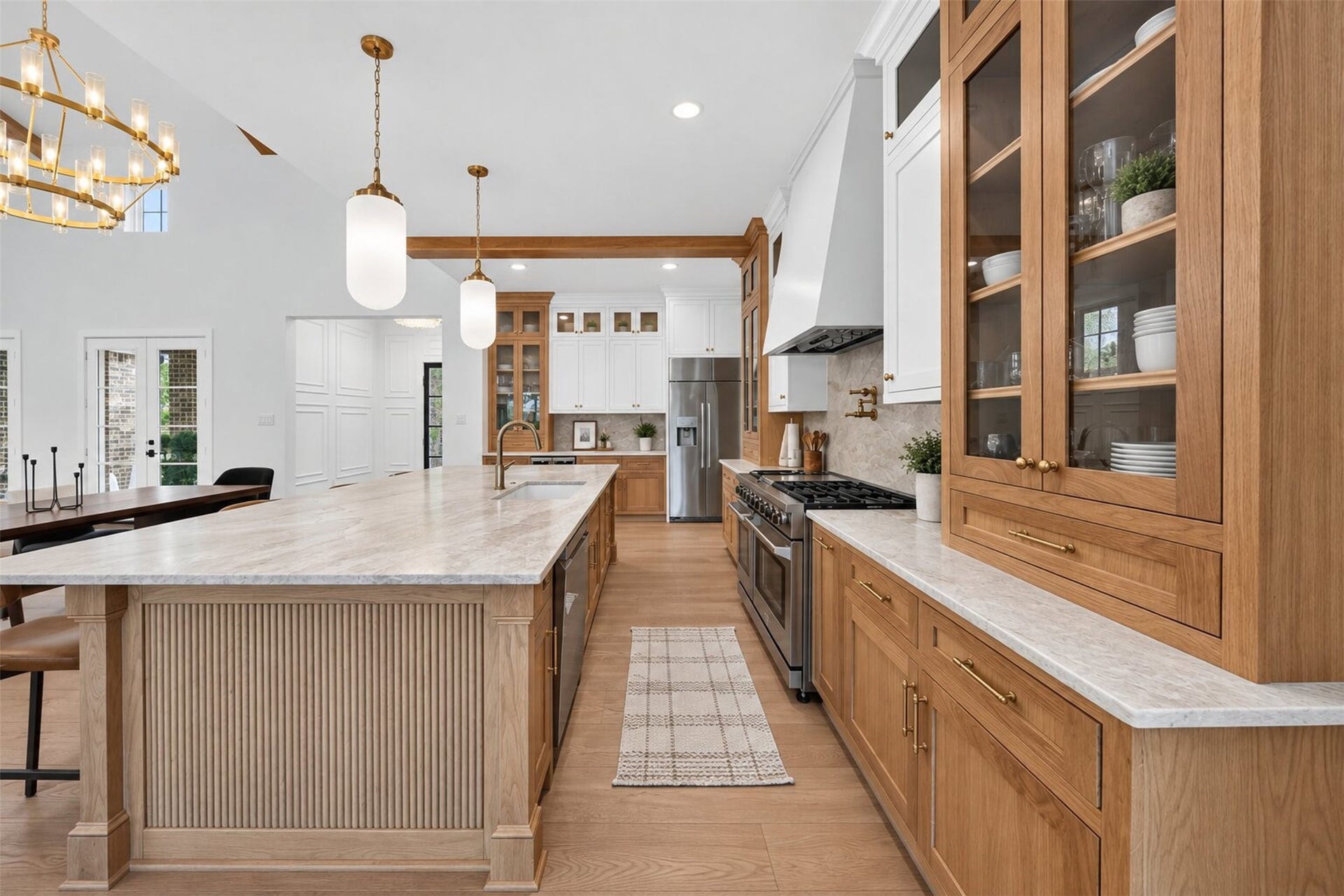 35851 Pineridge Road, Waller, TX 77484 A broad vent hood draws the eye to the cooking wall, with patterned tile and warm wood cabinetry framing the gas range.