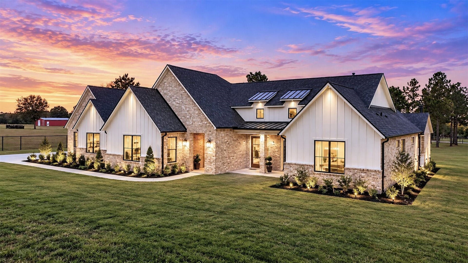35851 Pineridge Road, Waller, TX 77484 As evening falls, exterior lighting highlights the home's layered rooflines, brick facade, and recessed front entry.